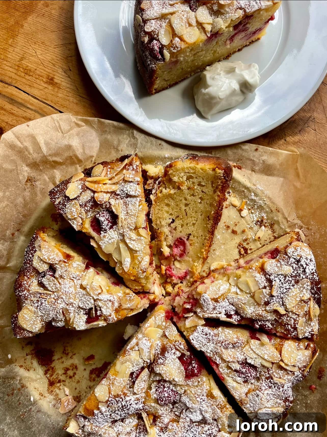 Divine Raspberry Almond Ricotta Cake 2 A beautifully sliced Raspberry, Almond and Ricotta Cake, showcasing vibrant raspberries and toasted almonds.
