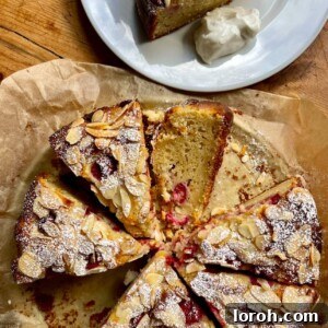 A tempting slice of Raspberry Almond and Ricotta Cake on a plate, ready to be served.