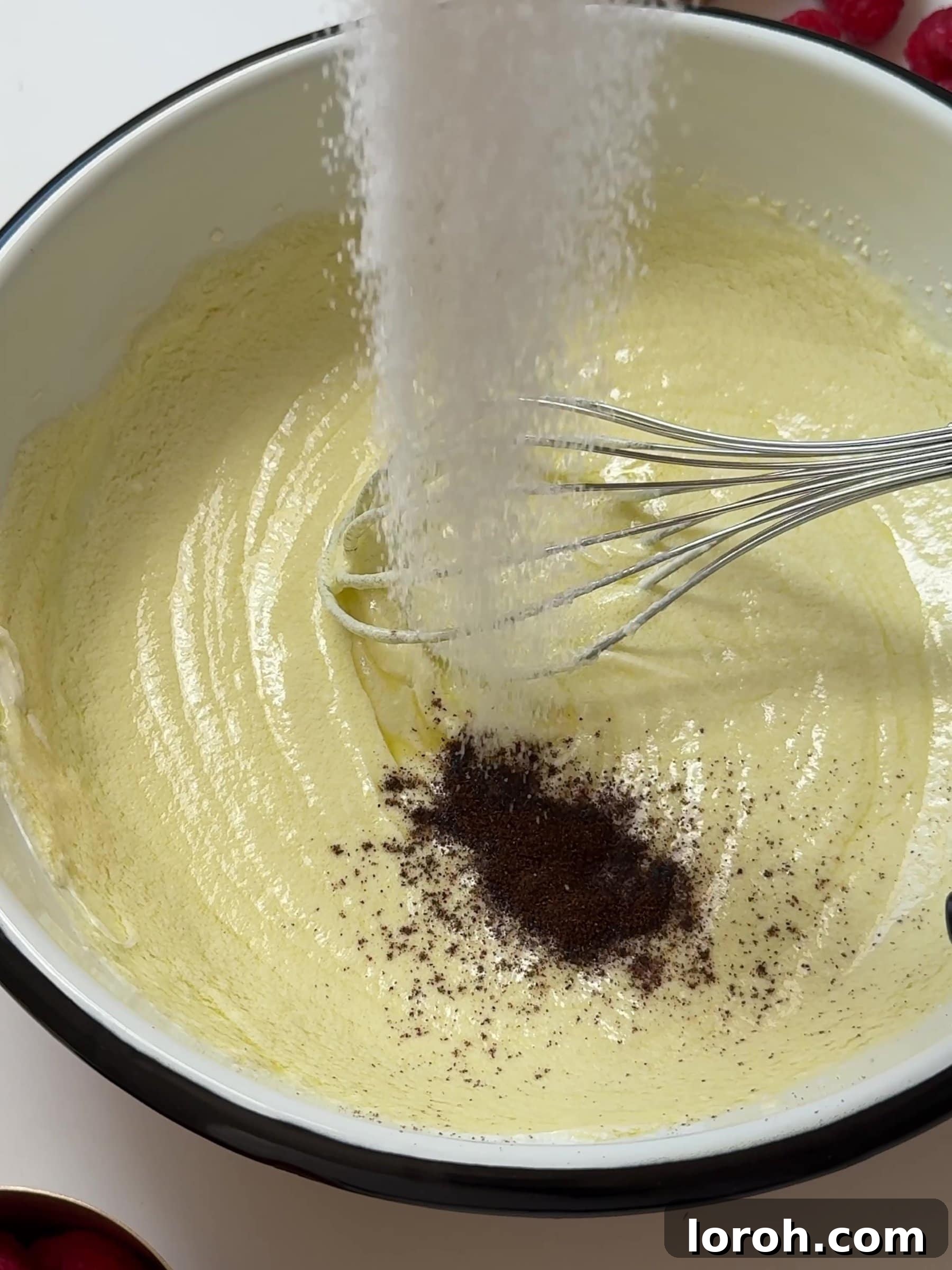 Divine Raspberry Almond Ricotta Cake 6 Adding vanilla extract and sugar to the ricotta mixture and whisking.