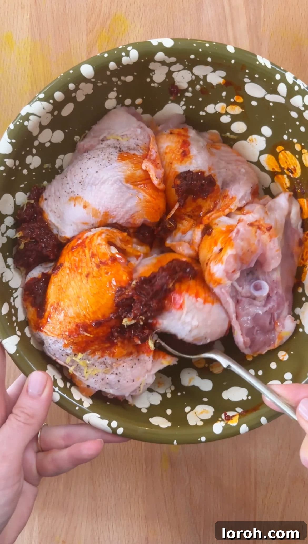 Step one: mixing chicken with harissa and lemon zest