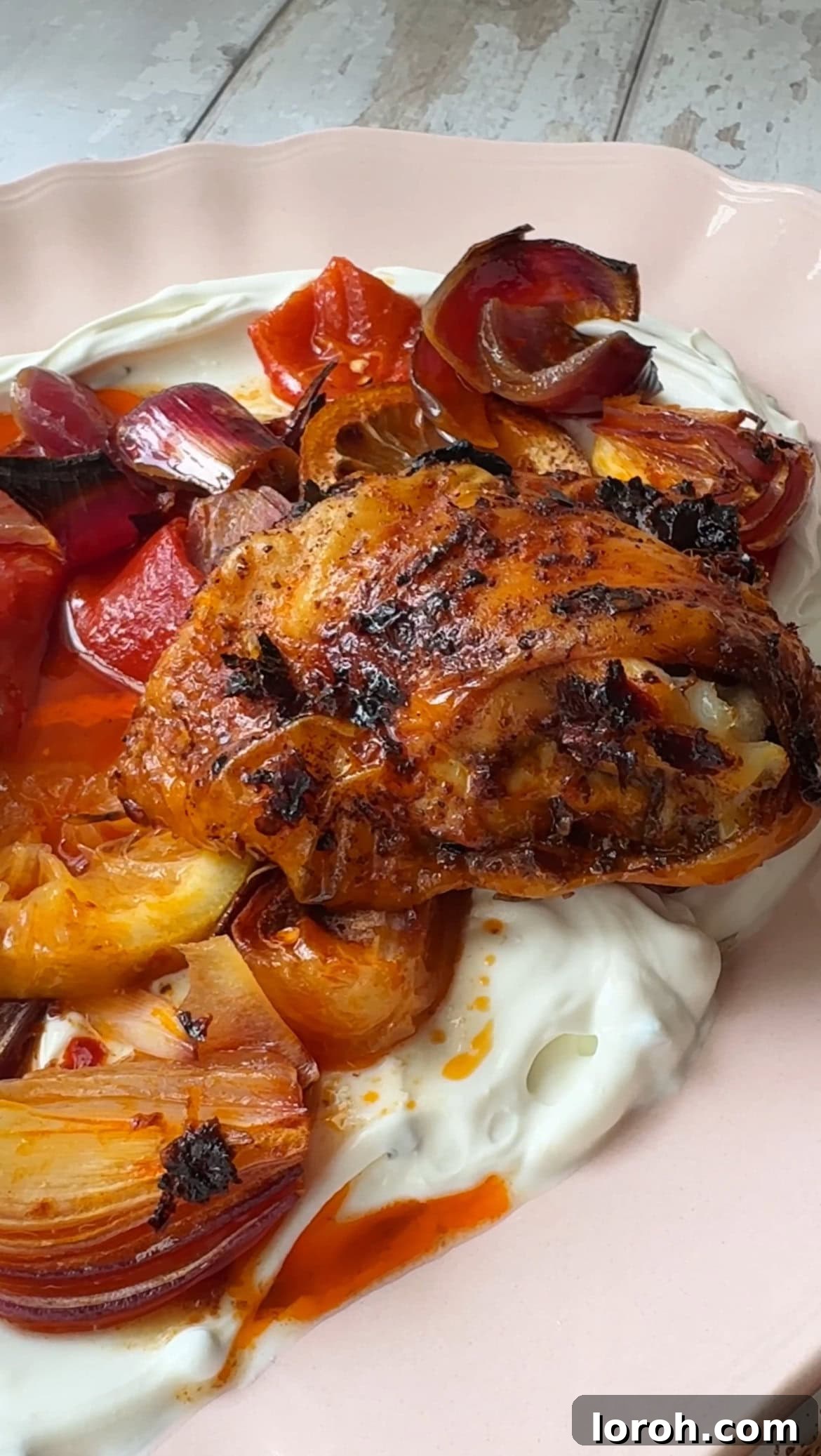 Step four: roasted harissa chicken on a plate with labneh
