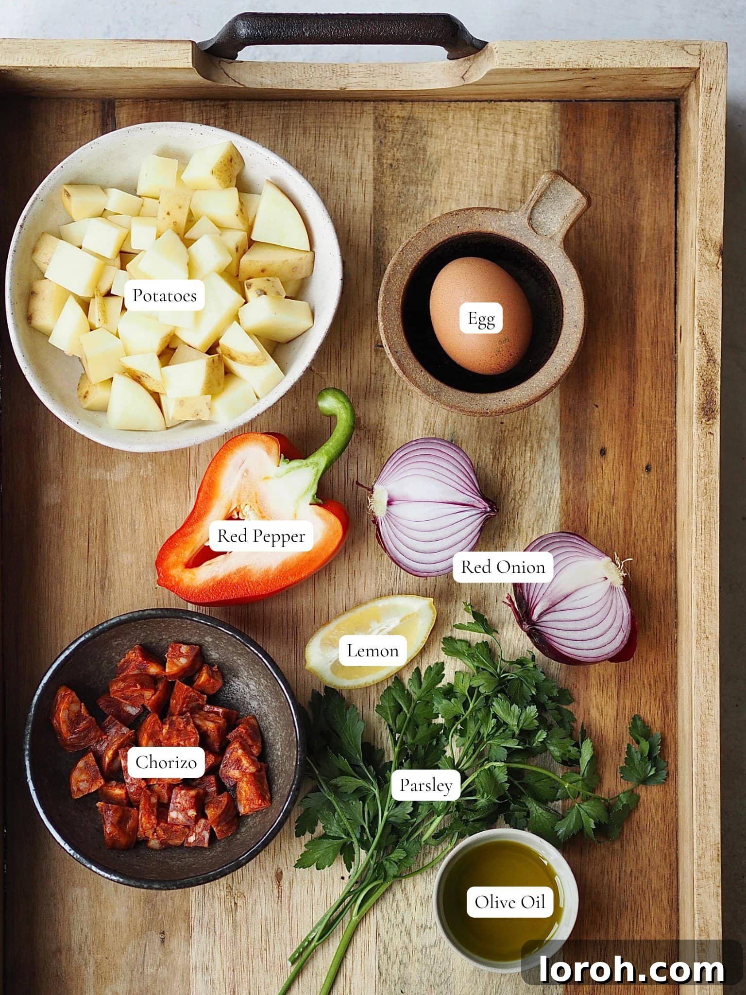 Smoky Chorizo and Potato Morning Skillet 3 Fresh ingredients laid out for Chorizo and Potato Breakfast Hash, including chorizo, potatoes, peppers, onions, and herbs.