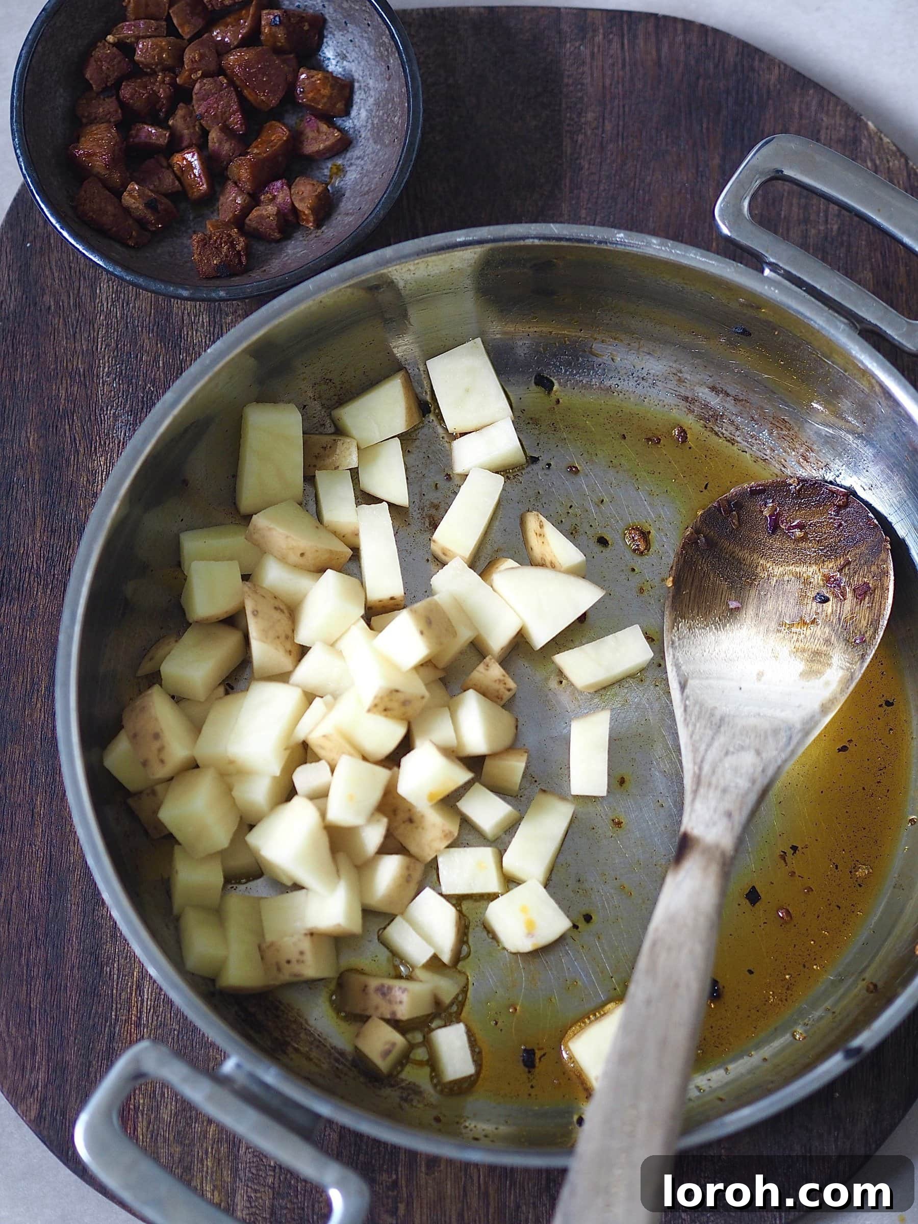Spicy Chorizo and Golden Potato Morning Skillet 7 Adding par-boiled and dried potato cubes to the pan with chorizo oil, ready to be crisped.