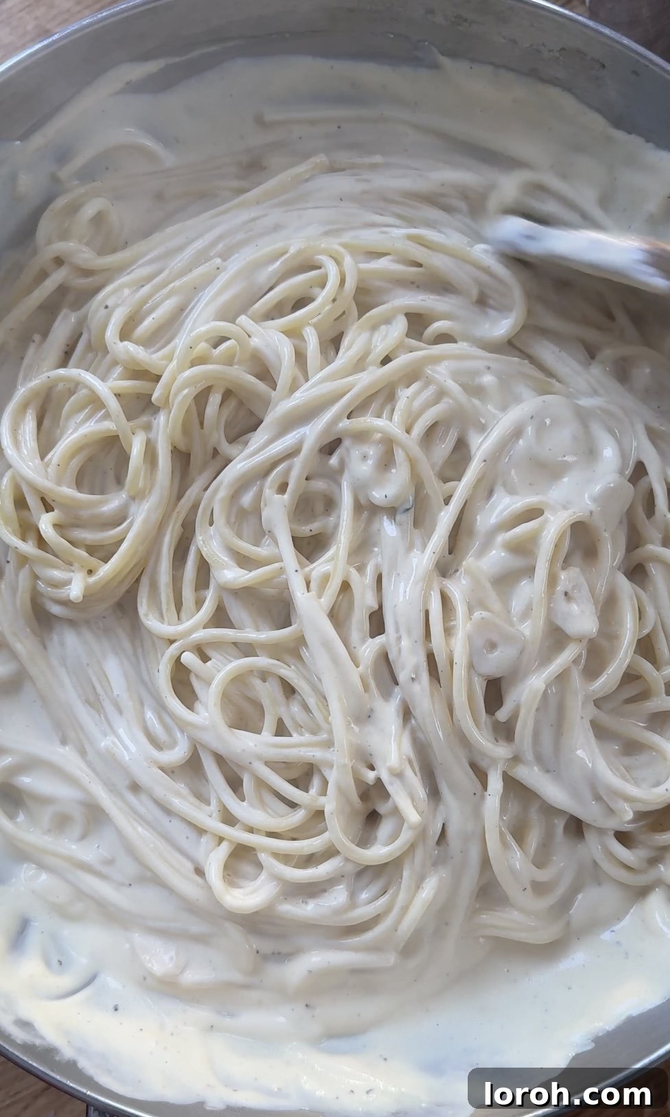 Velvety Chicken Pasta 11 Tossing the creamy chicken pasta together in the pan until well combined and glistening.