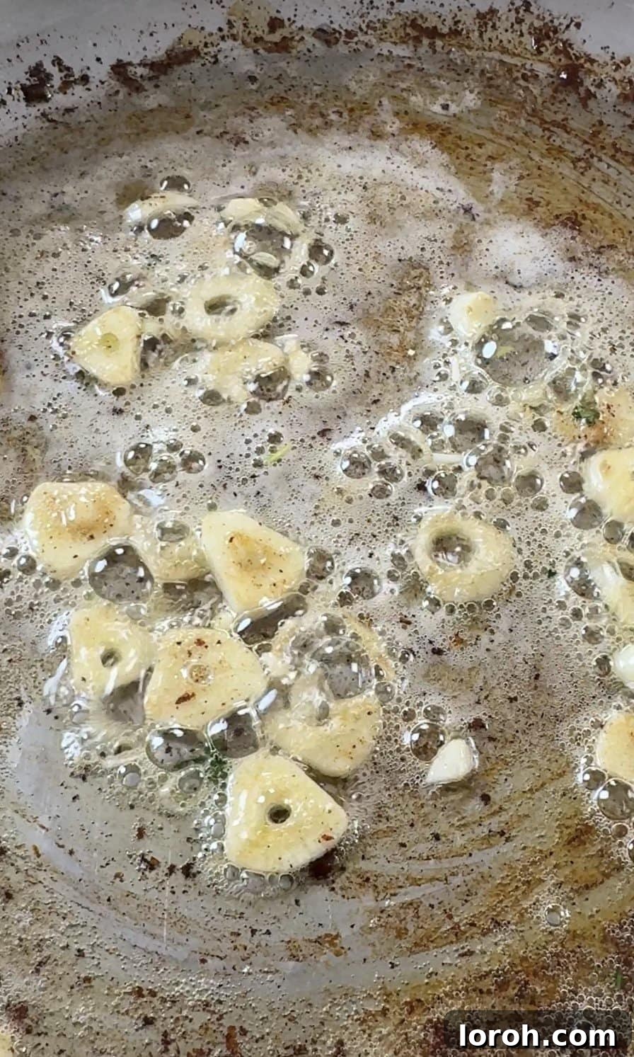 Velvety Chicken Pasta 6 Finely sliced garlic sizzling in melted butter in the same pan used for chicken, absorbing rich flavors.