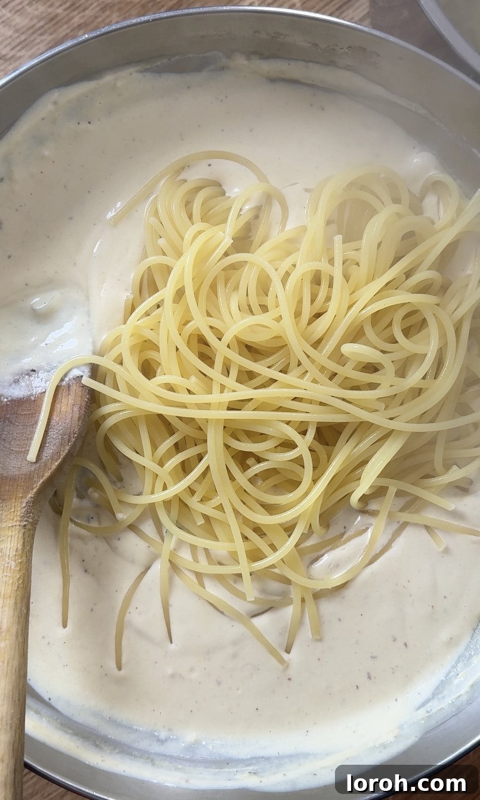 Velvety Chicken Pasta 10 Adding perfectly cooked pasta directly into the creamy chicken sauce in the pan.