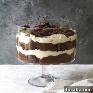 A vibrant and luscious Chocolate Brownie Trifle in a clear glass dish, beautifully layered.