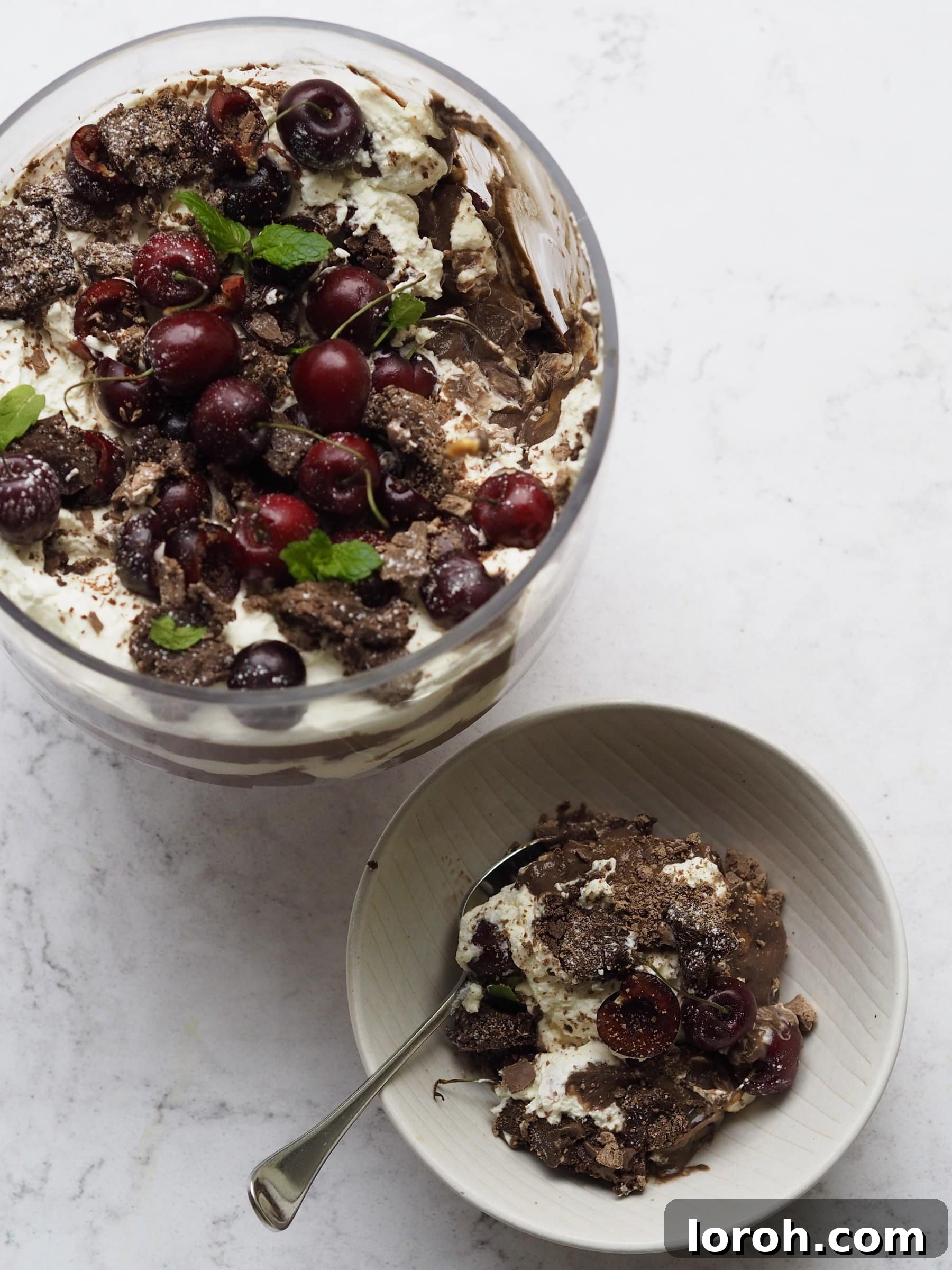 A close-up view of the distinct, delectable layers of a Chocolate Brownie Trifle, showcasing its rich texture and festive appearance.