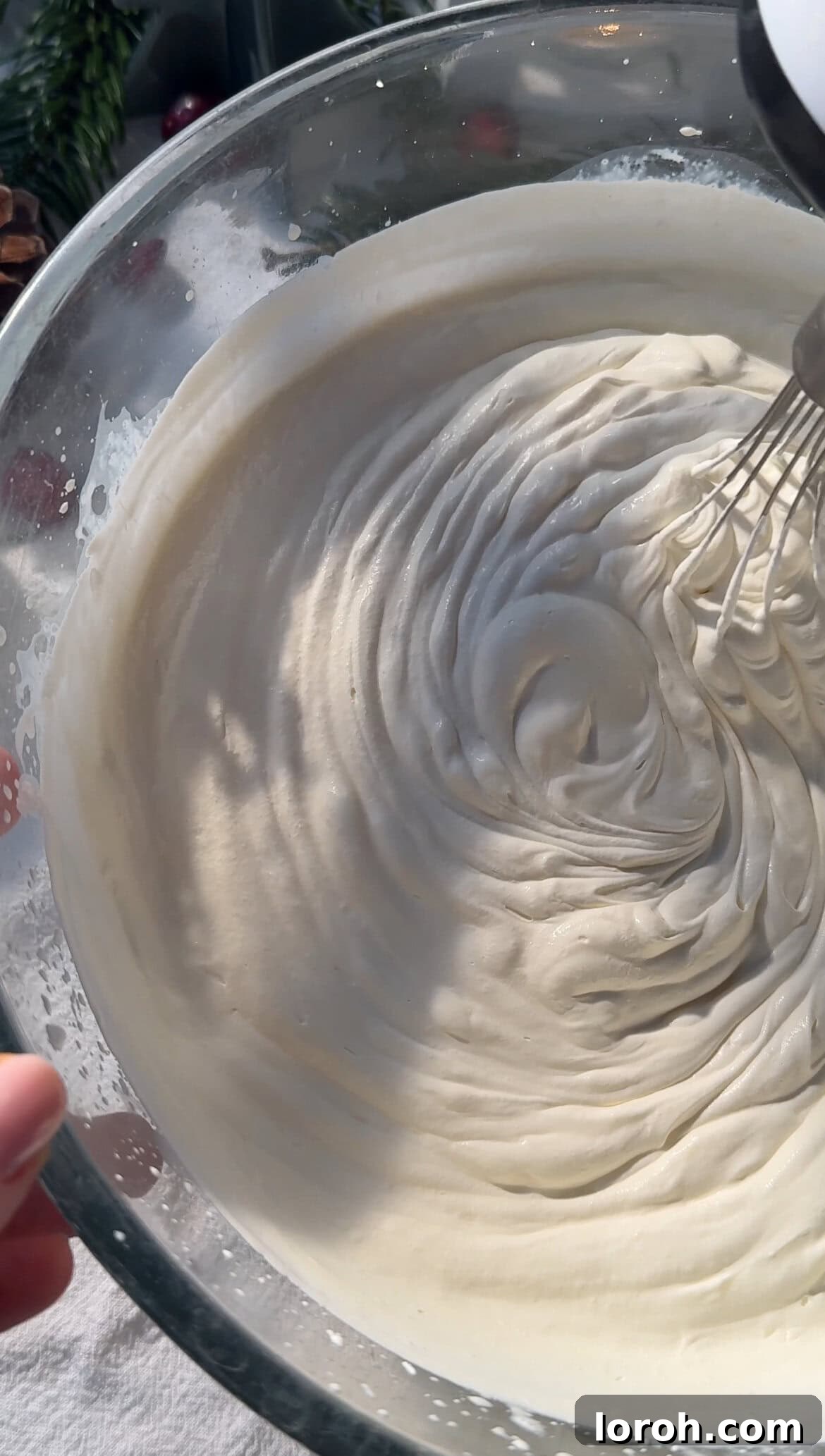 Double cream being whipped in a stand mixer to soft peaks for homemade chocolate mousse.