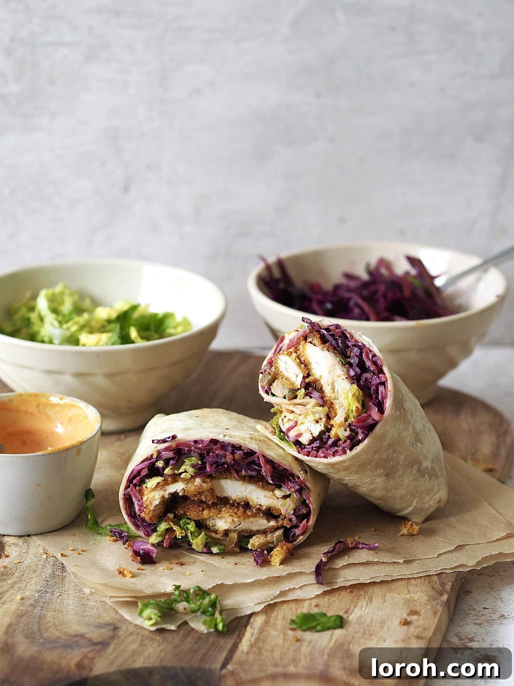 Katsu Crunch Wrap 3 Hand holding a perfectly wrapped Chicken Katsu Wrap, ready to eat.