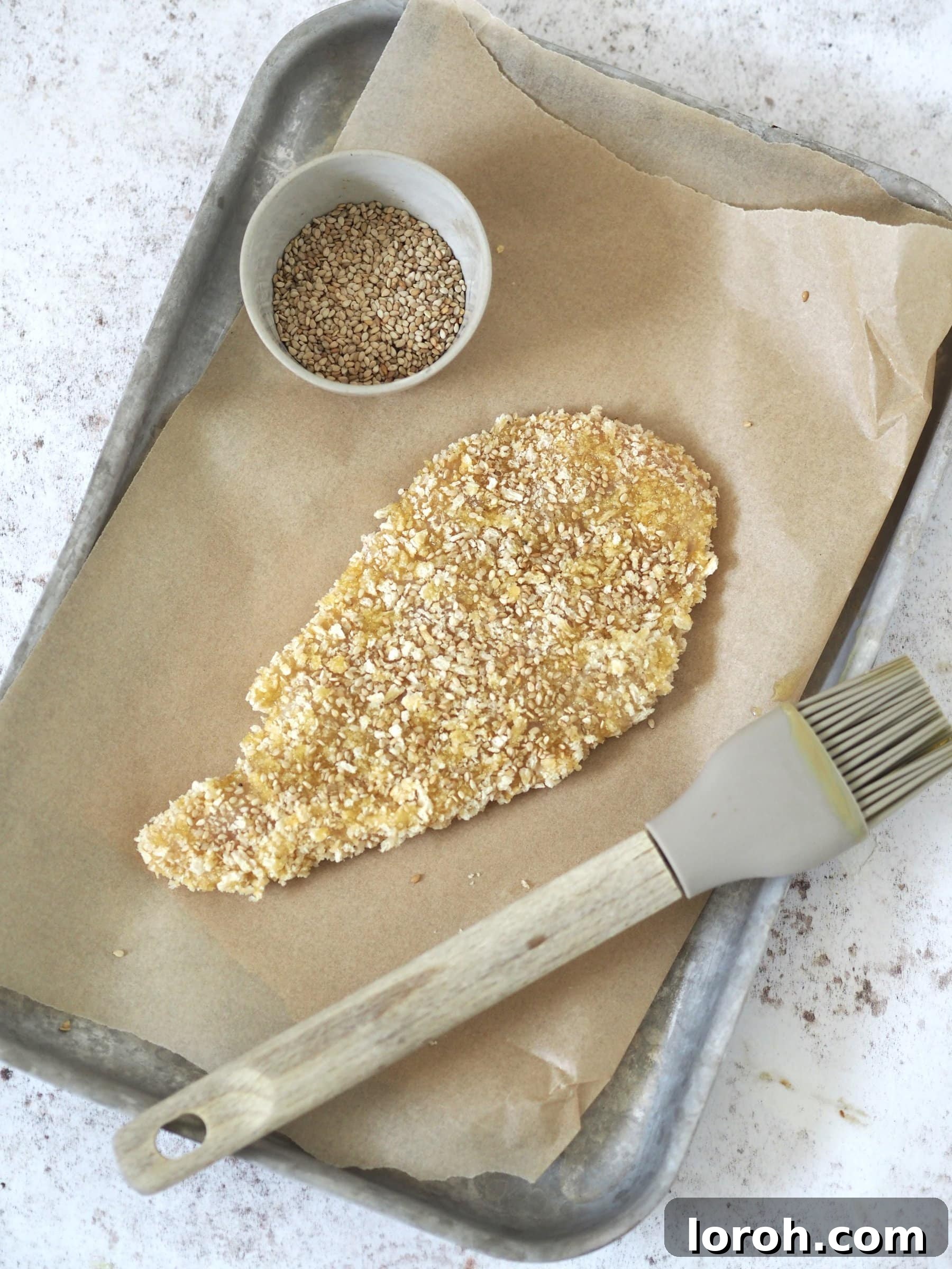 Crispy Katsu Sando 5 Coating a butterflied chicken breast in panko breadcrumbs for Chicken Katsu Sandwich.