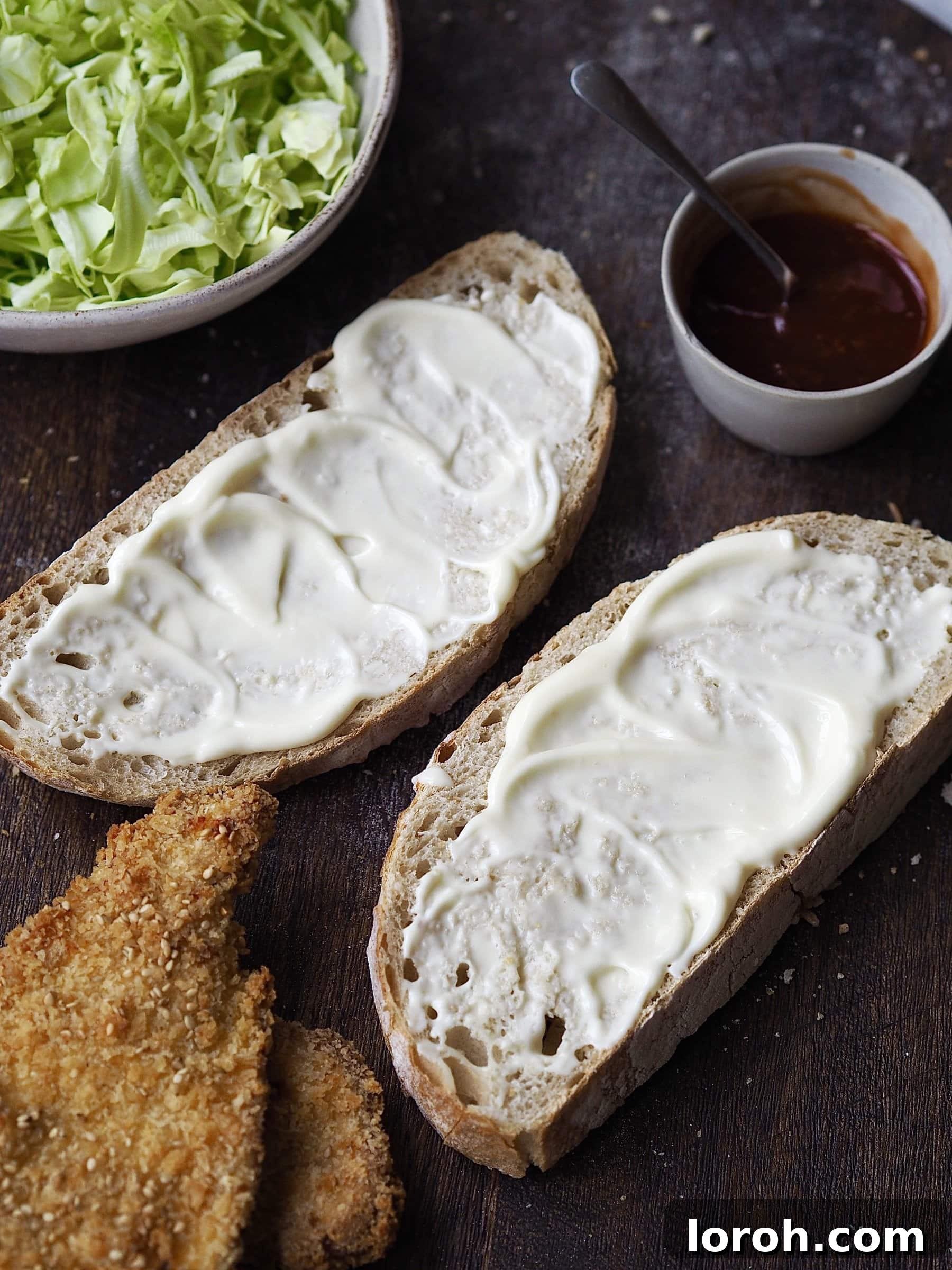 Crispy Katsu Sando 6 Spreading Kewpie mayonnaise on a slice of white bread for Chicken Katsu Sandwich.
