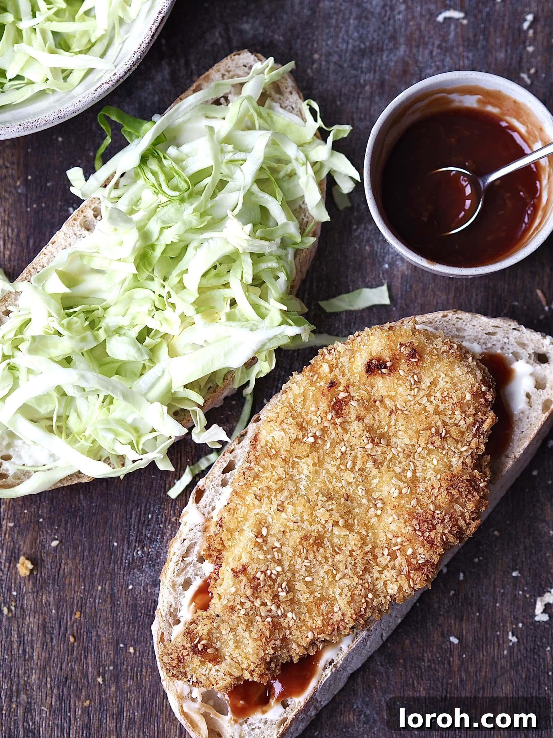 Crispy Katsu Sando 7 Assembling a Chicken Katsu Sandwich with crispy chicken and shredded cabbage.