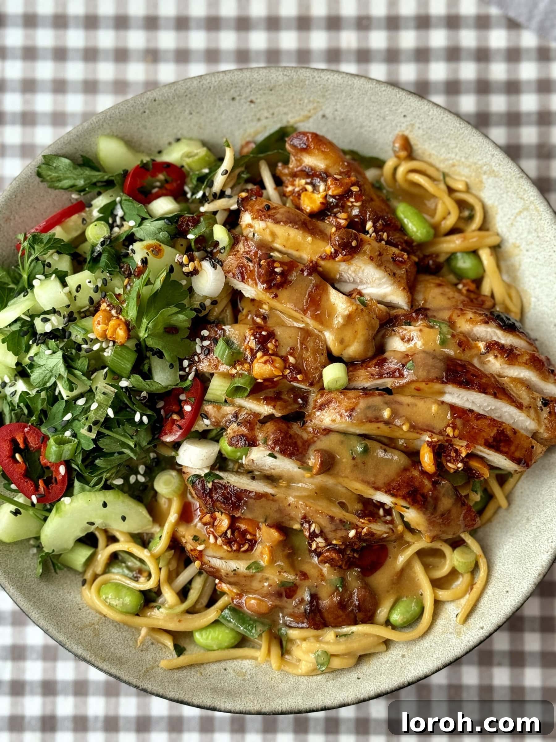 Another perspective of the Chicken Noodle Bowl, showing the ingredients tossed together with the dressing.
