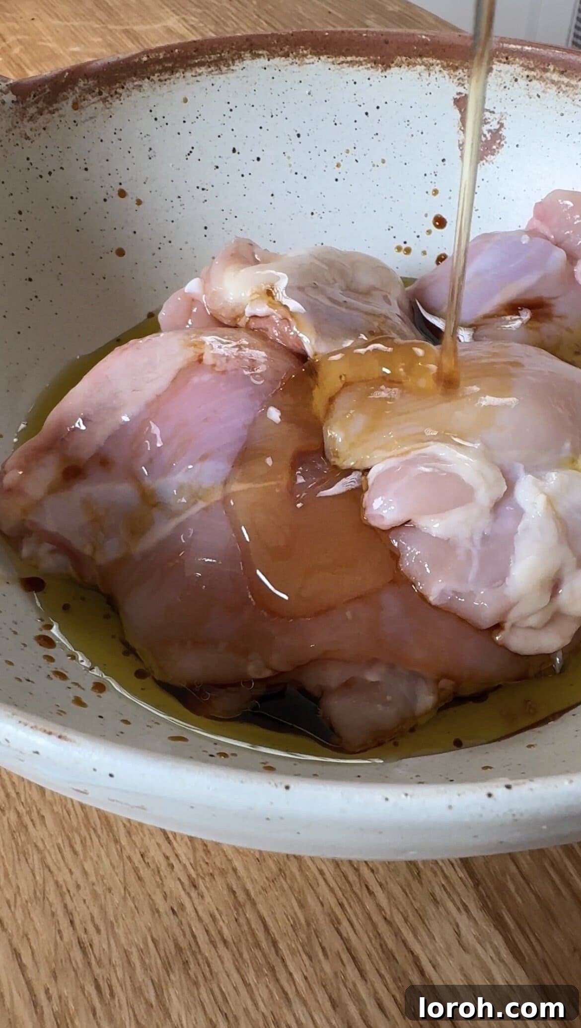 Step one: Marinating the chicken thighs in a bowl.
