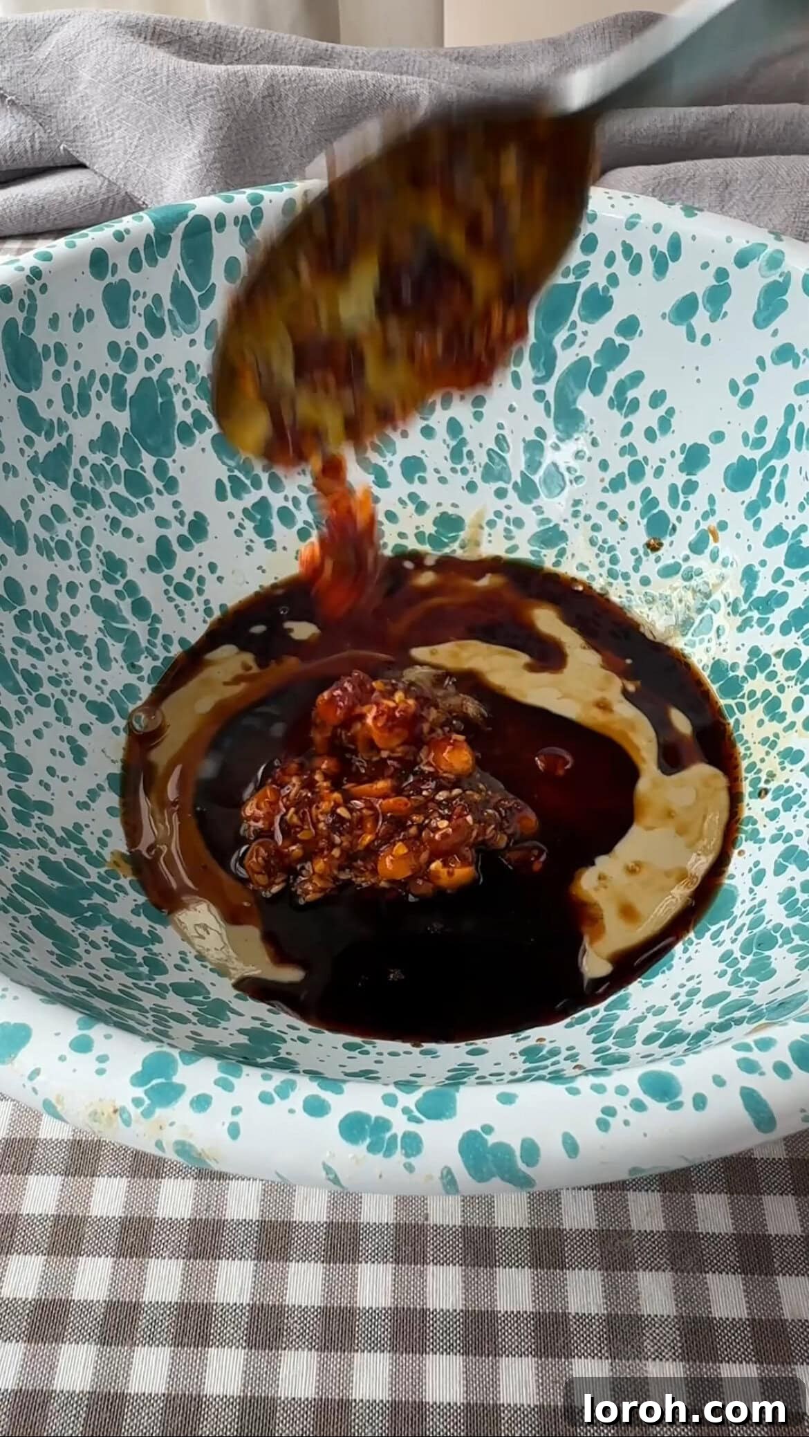 Step three: Whisking together the tahini-chilli dressing.