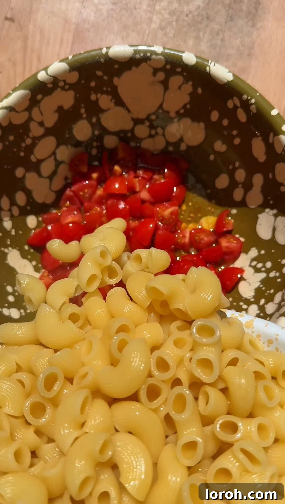 Creamy Chicken Macaroni Delight 5 adding cooked pasta to marinated tomatoes in a bowl