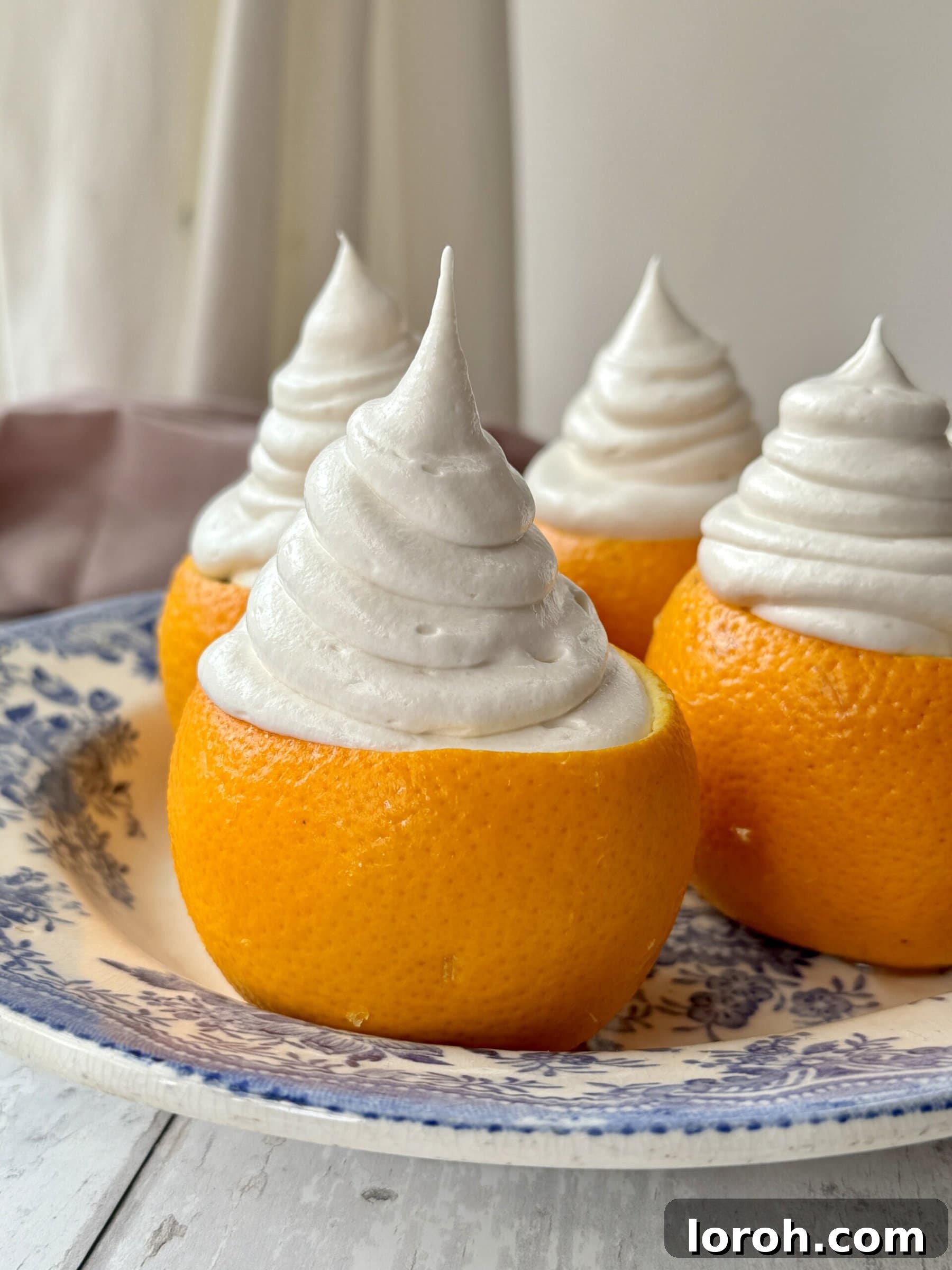 Citrus Cocoa Cloud 4 A selection of essential ingredients for chocolate orange mousse, including chocolate, eggs, oranges, and cream, beautifully arranged.