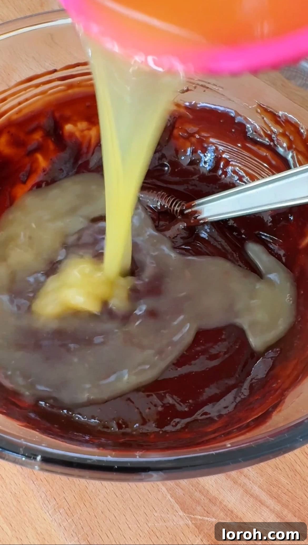 Citrus Cocoa Cloud 7 Melted chocolate in a bowl with orange juice being added, ready for mixing to create the mousse base.