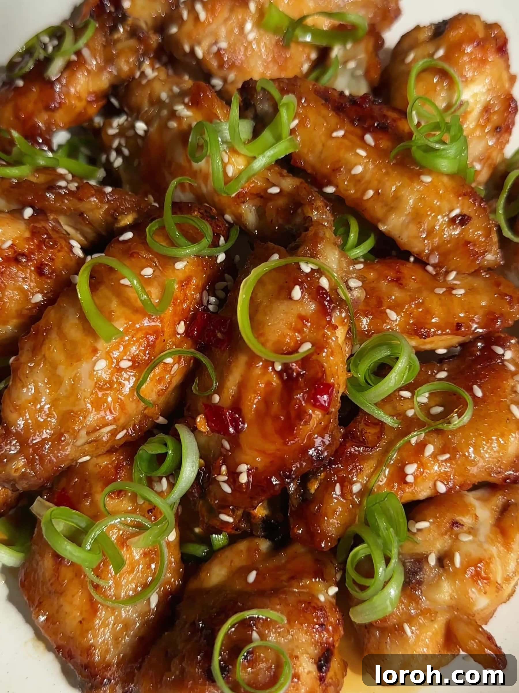 Crispy Hot Honey Chicken Wings glistening with sweet and spicy sauce.