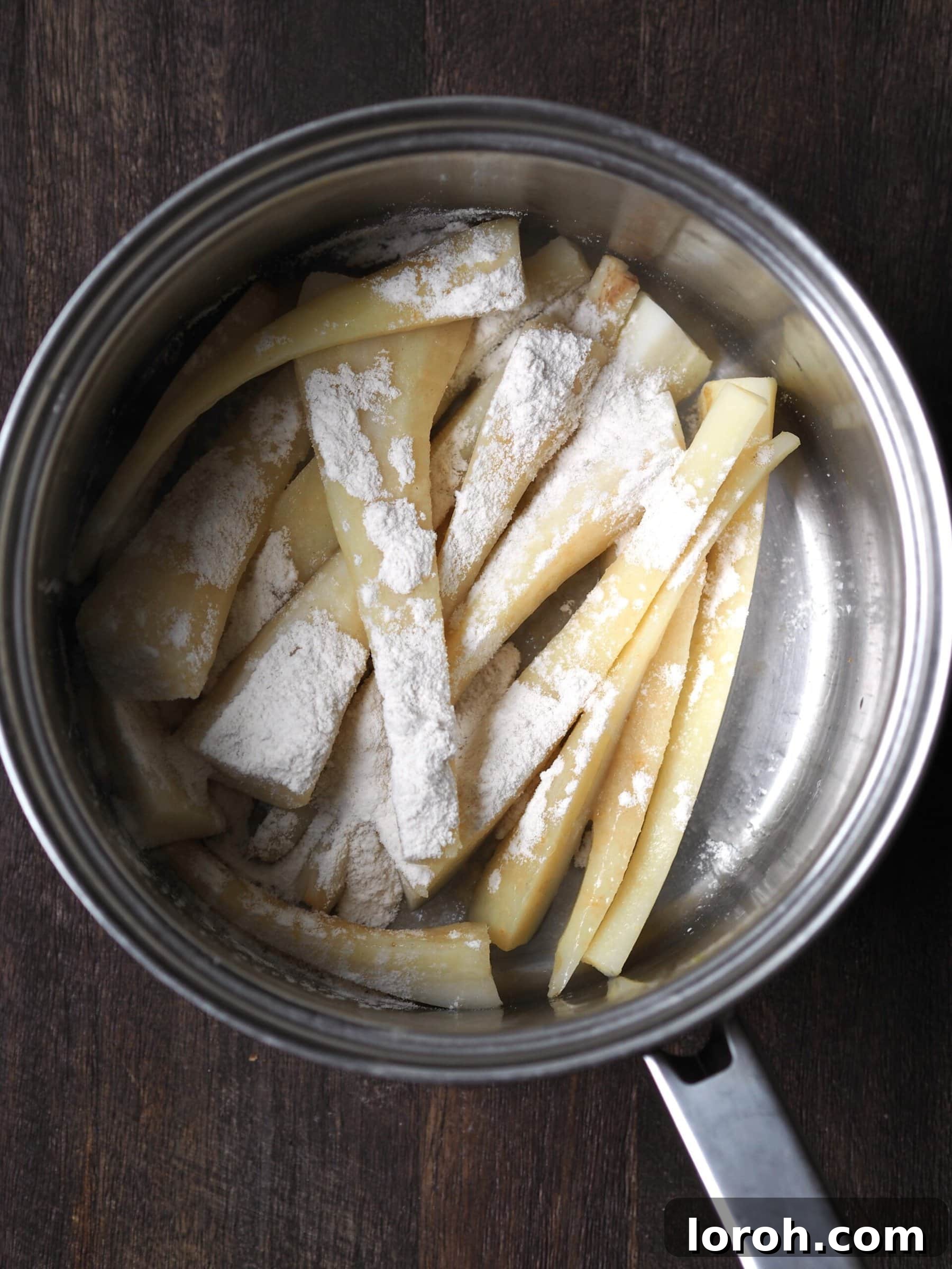 Par-boiled parsnips steaming in a saucepan, ready for the next step.