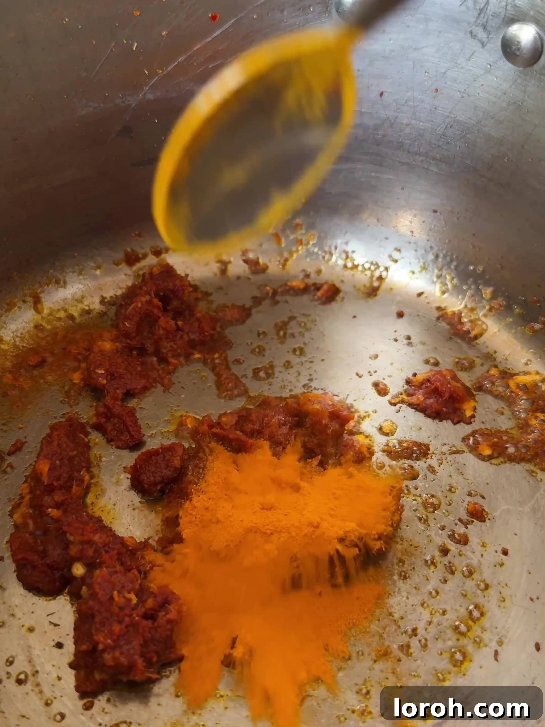 Aromatic Wonton Noodle Delight 7 Adding turmeric to the curry paste and garlic mixture