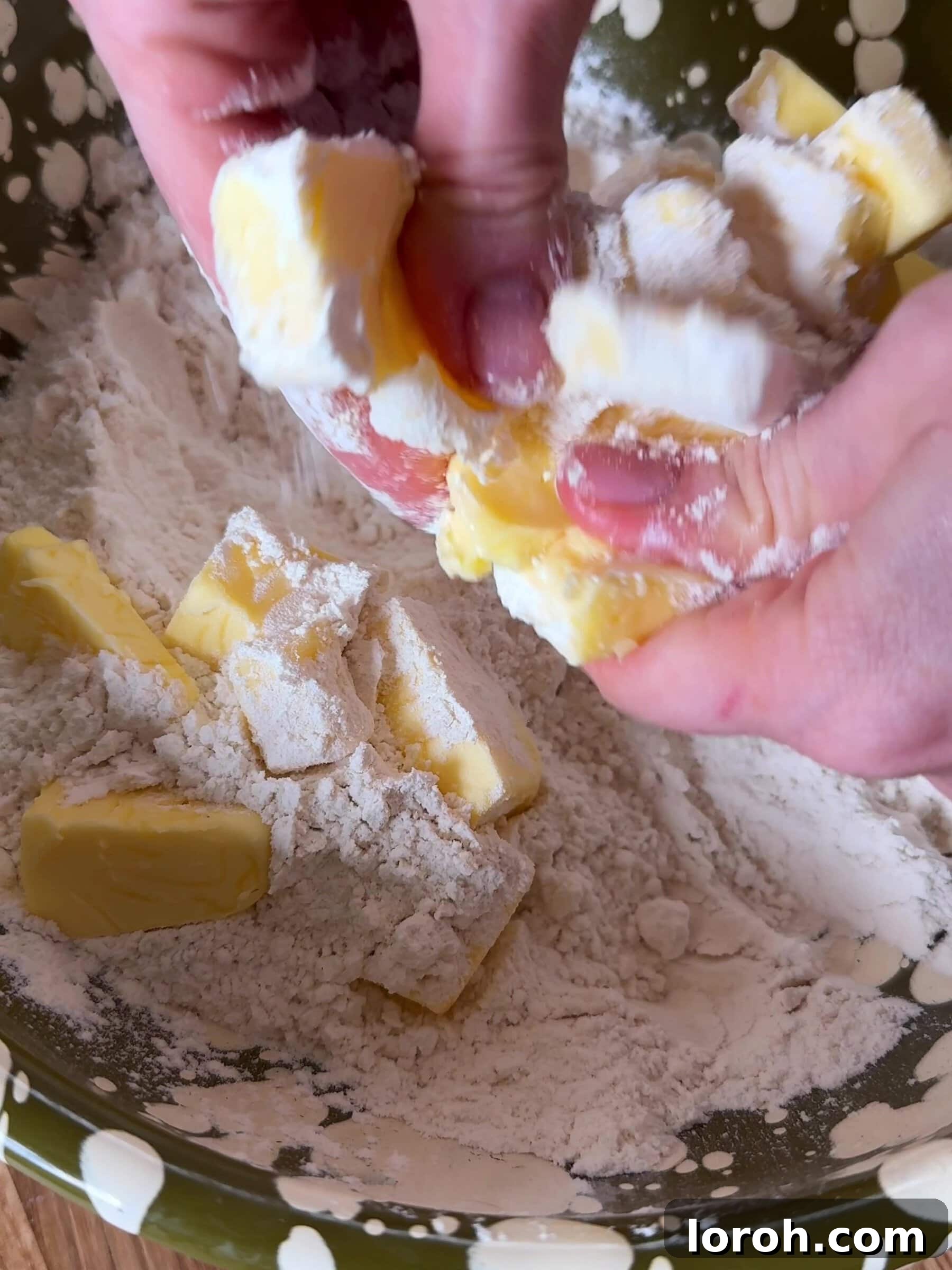 Mixing butter and flour with fingertips for crumble