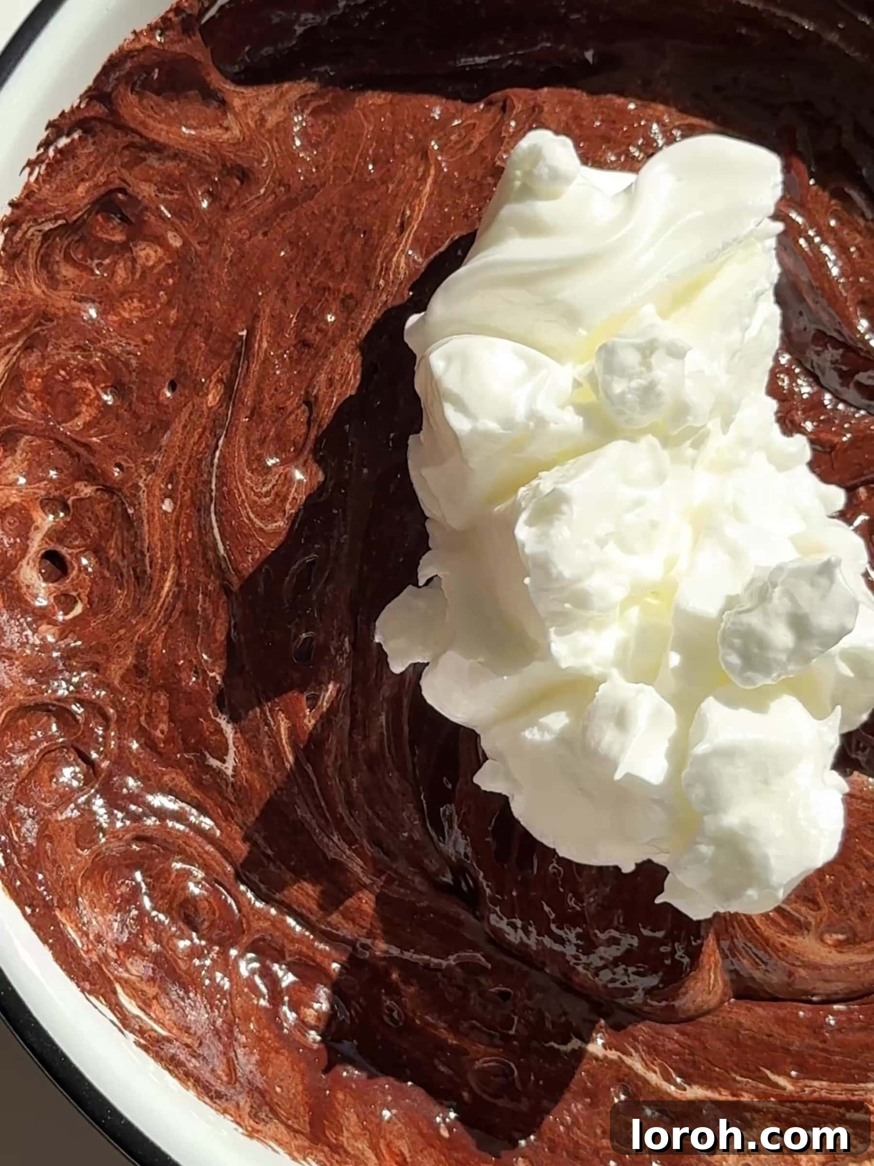 Gently folding whisked egg whites into the chocolate and egg yolk mixture for Moelleux au Chocolat.