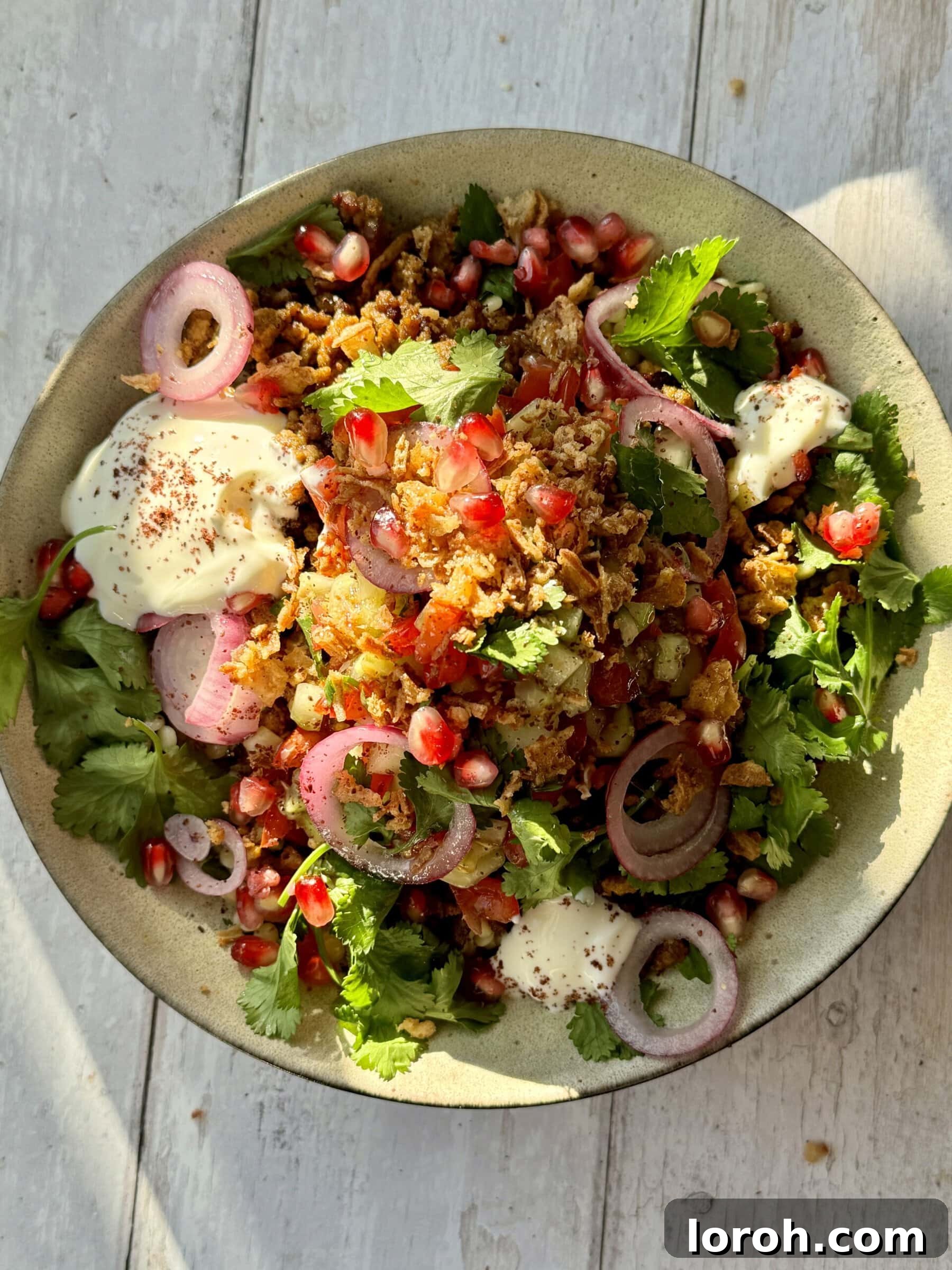 Golden Lamb & Couscous with Bright Herb Salad 2 A vibrant bowl of crispy lamb mince with couscous, fresh salad, and garnishes, ready to be enjoyed.
