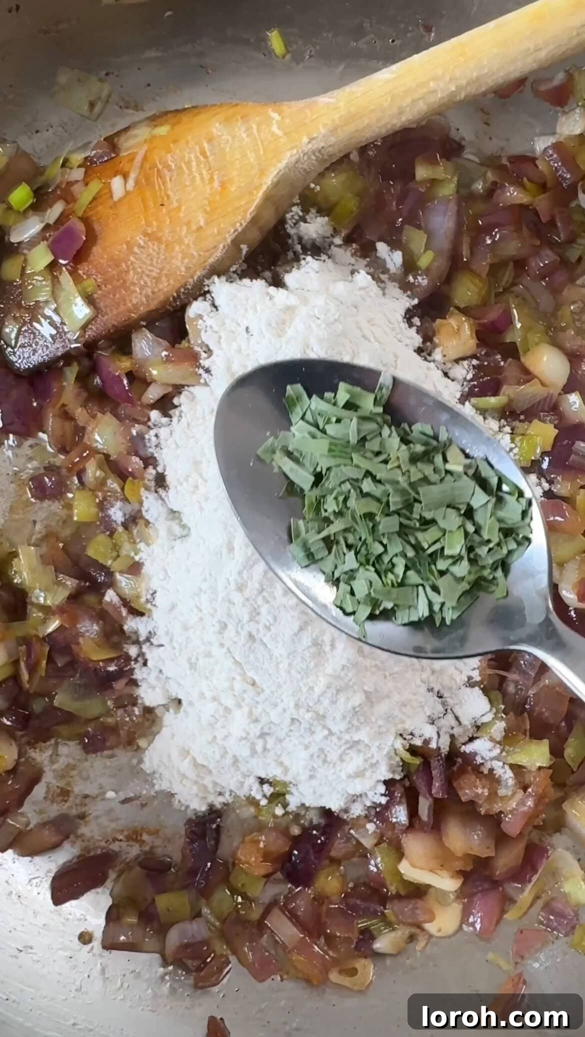 All-purpose flour and dried tarragon being stirred into the sautéed onion and leek mixture, forming the base of the roux.