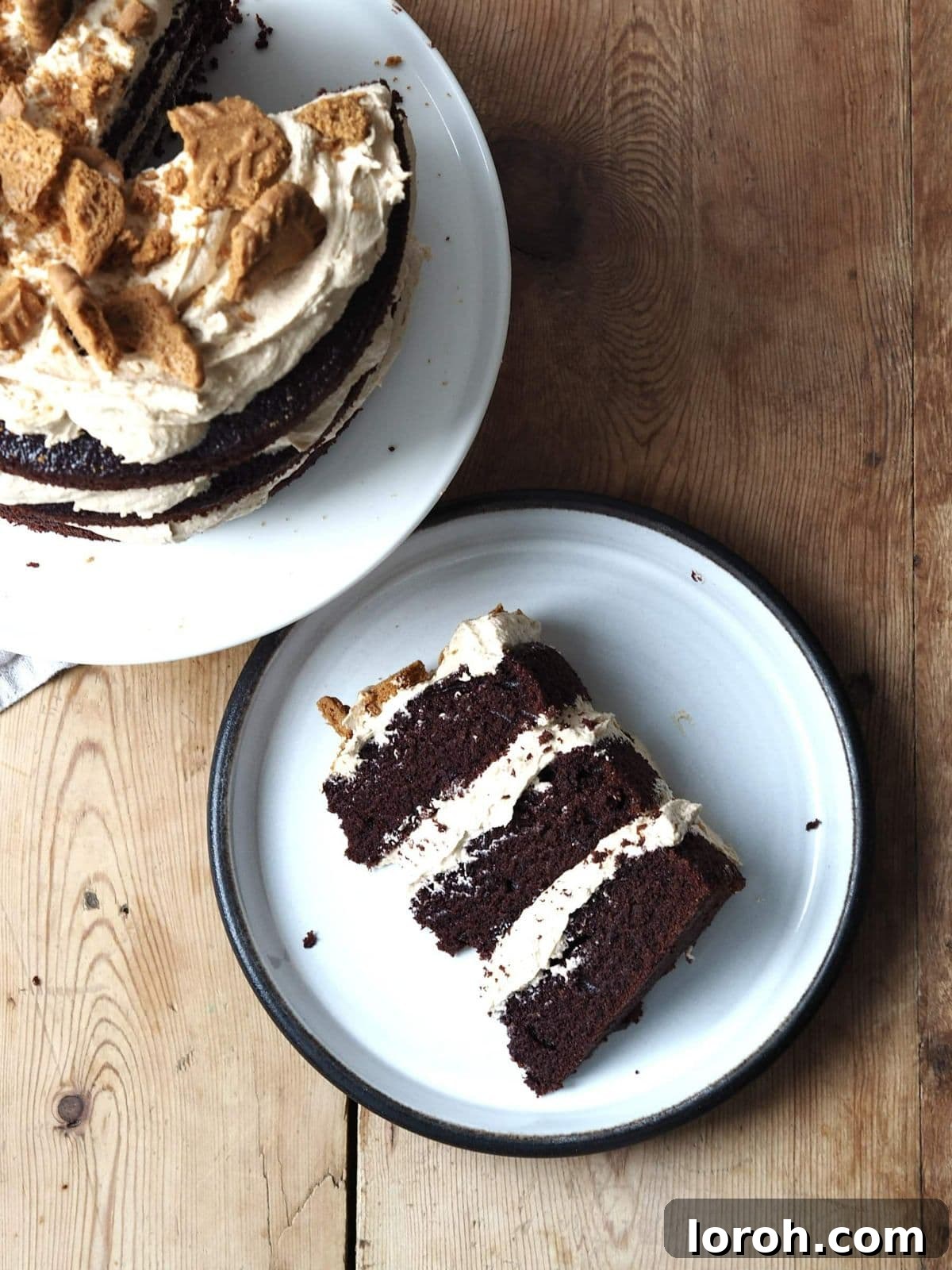 A delicious slice of Biscoff cake placed on a simple white plate, ready to be enjoyed.