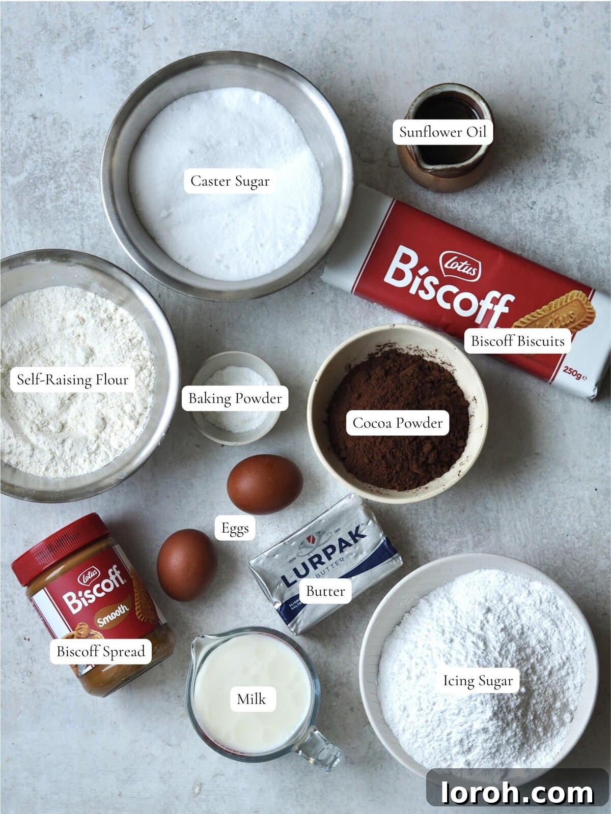 Clearly labeled ingredients, including flour, cocoa powder, sugar, oil, and Biscoff spread, laid out for baking the Biscoff cake.