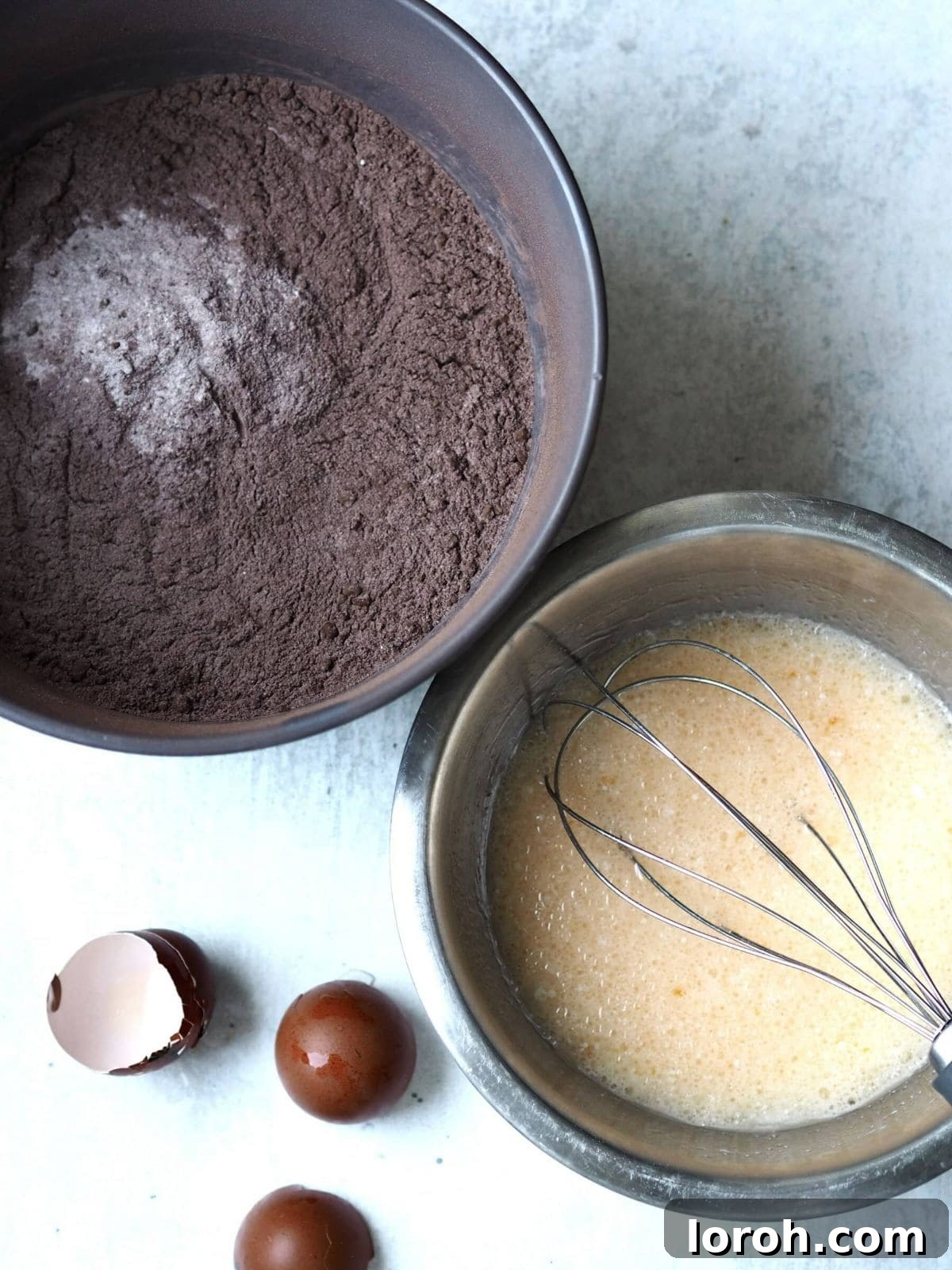 Two separate bowls are shown: one with dry ingredients for the cake, and another with wet ingredients like eggs, milk, and oil.