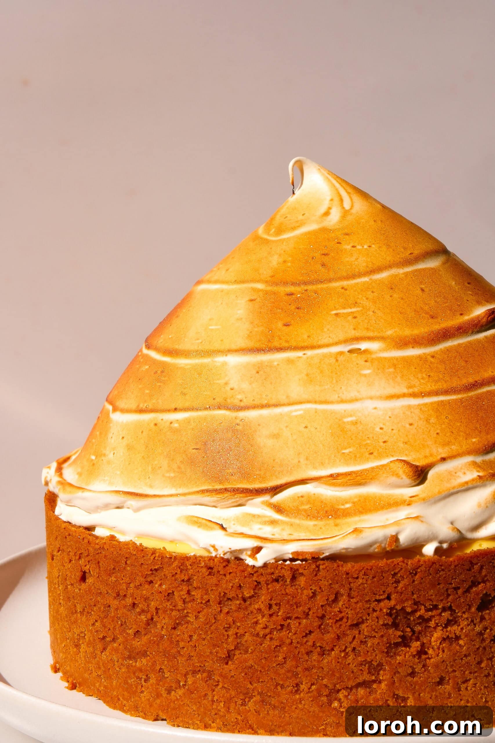 Zesty Lemon Meringue Delight 2 whole lemon meringue cheesecake, beautifully decorated with torched meringue