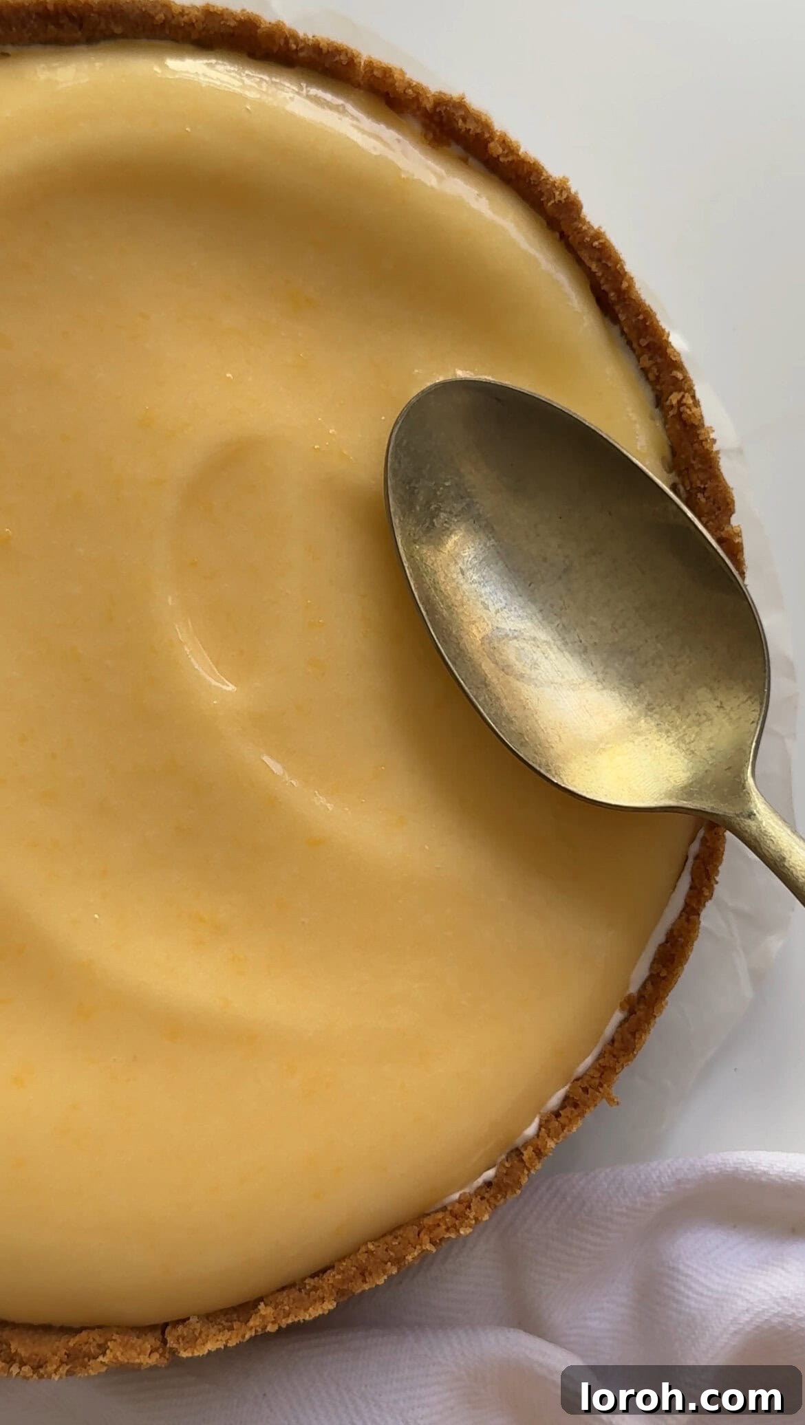 Zesty Lemon Meringue Delight 13 spreading cooled lemon curd evenly over the set cheesecake base