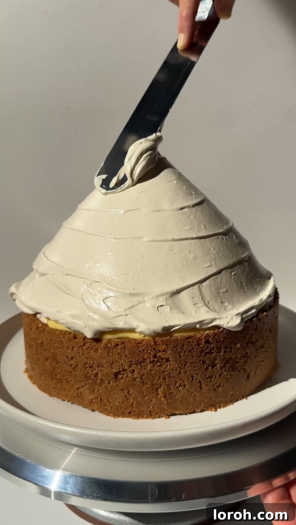 Zesty Lemon Meringue Delight 15 piping or spreading glossy Italian meringue over the lemon curd layer of the cheesecake
