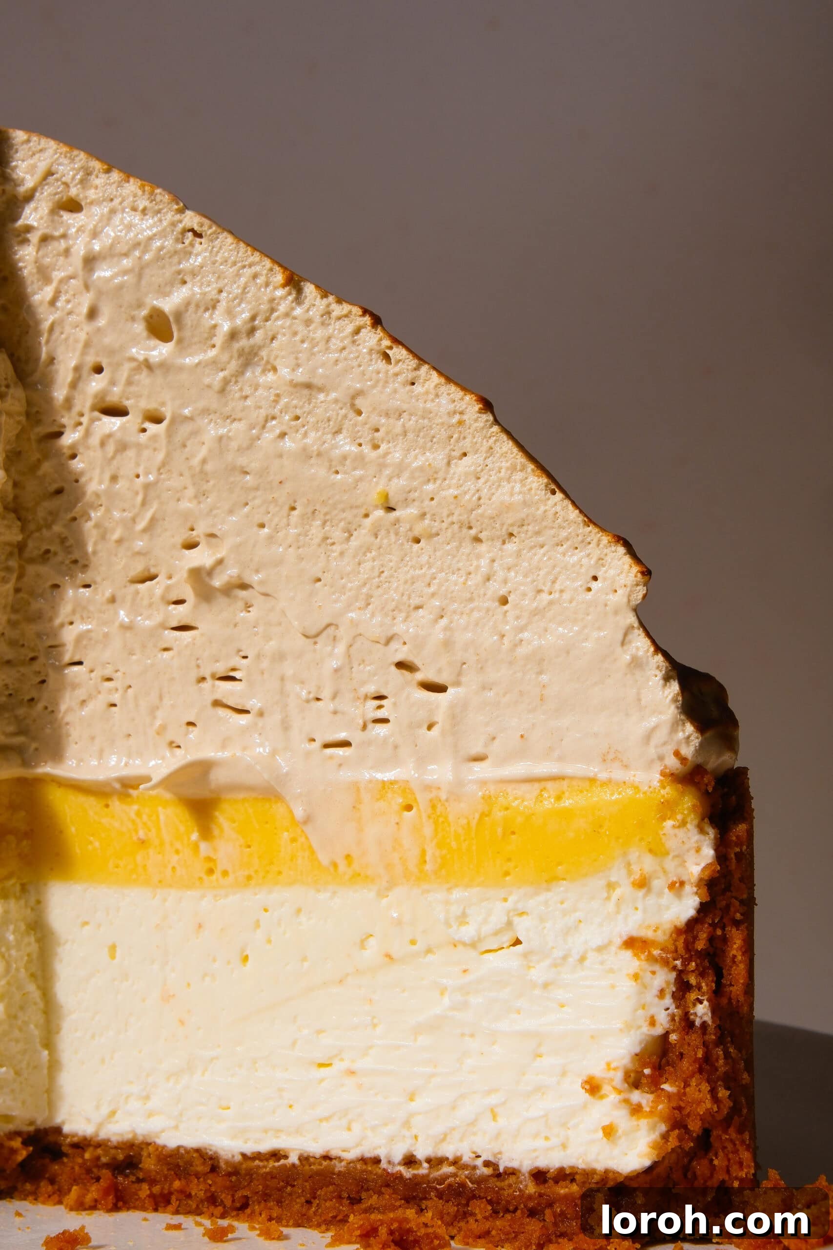 Zesty Lemon Meringue Delight 18 close-up of a slice of lemon meringue cheesecake, showing the fluffy meringue and smooth layers