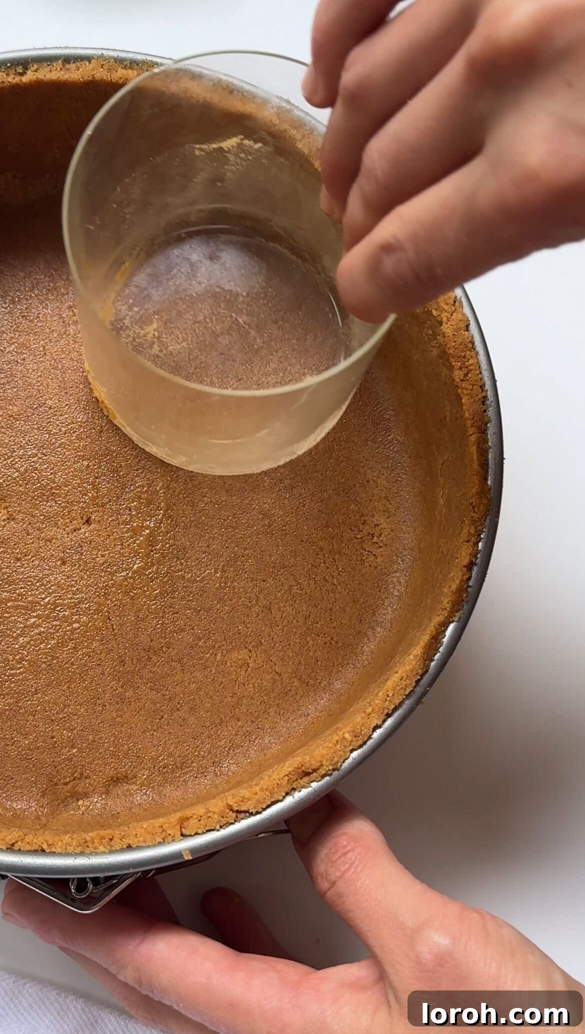 Zesty Lemon Meringue Delight 8 pressing biscuit mixture into a springform tin to form the base
