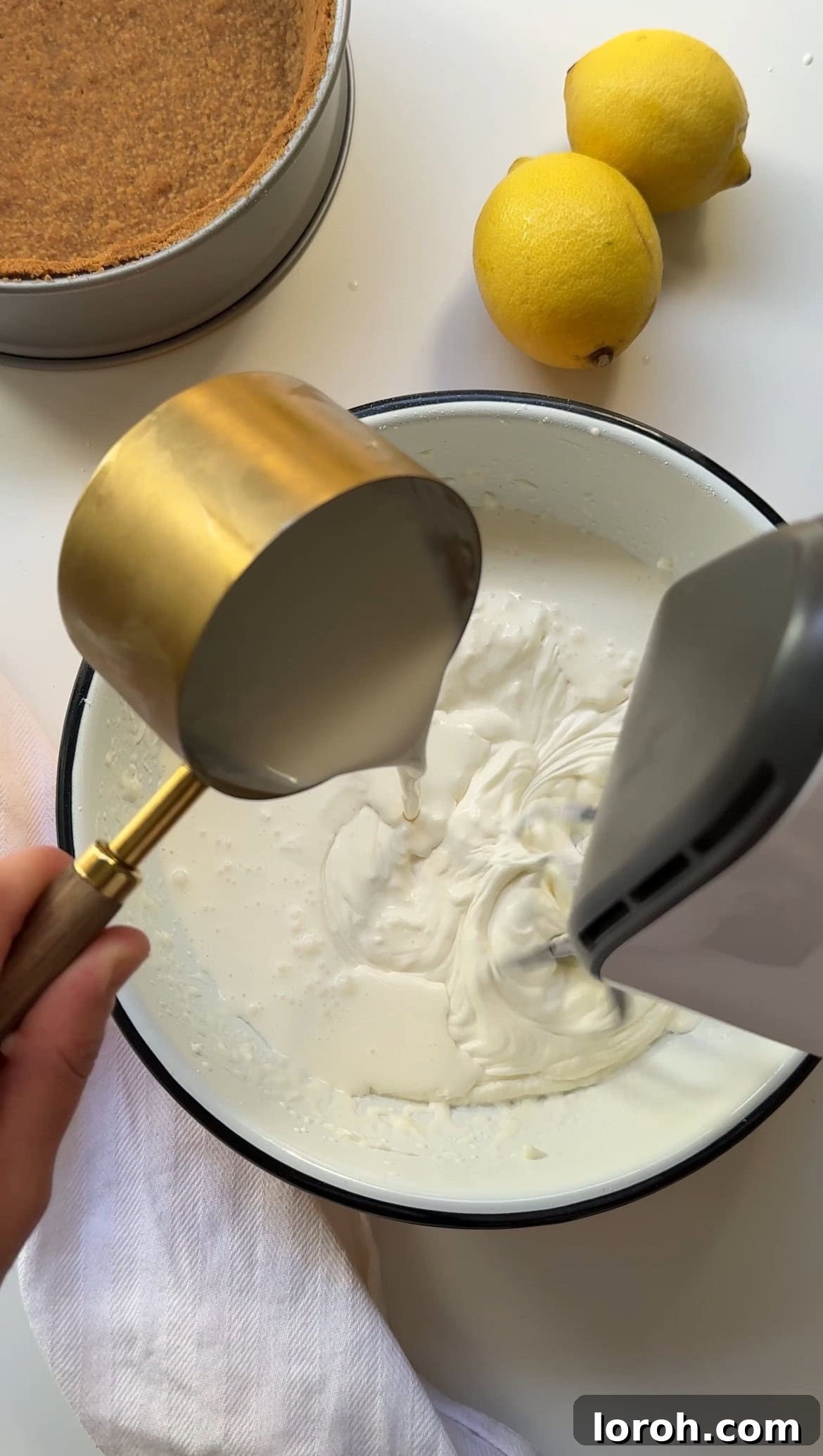 Zesty Lemon Meringue Delight 9 gradually pouring double cream into the cream cheese mixture while whisking