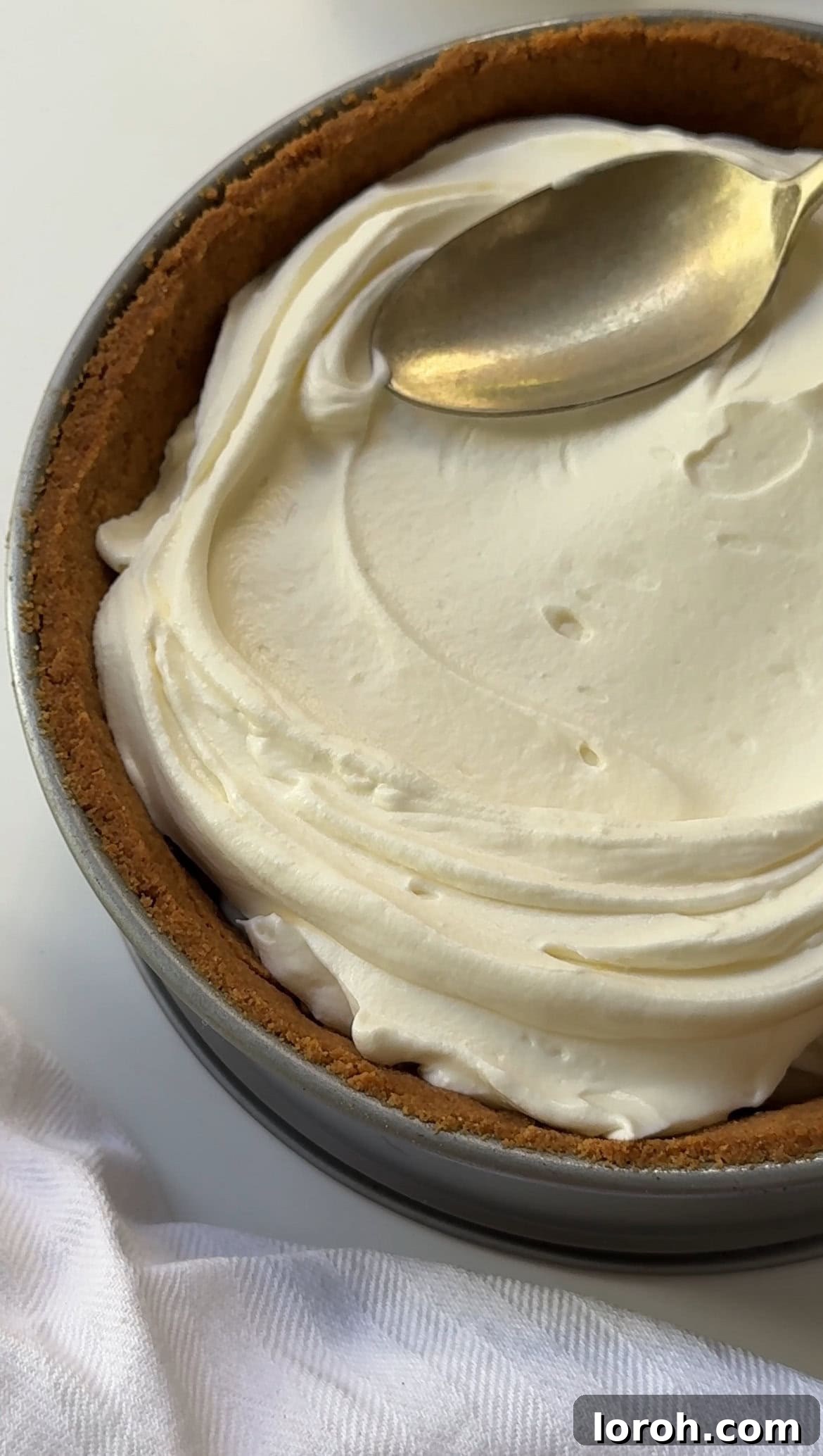 Zesty Lemon Meringue Delight 10 smoothing the lemon cheesecake filling onto the cooled biscuit base