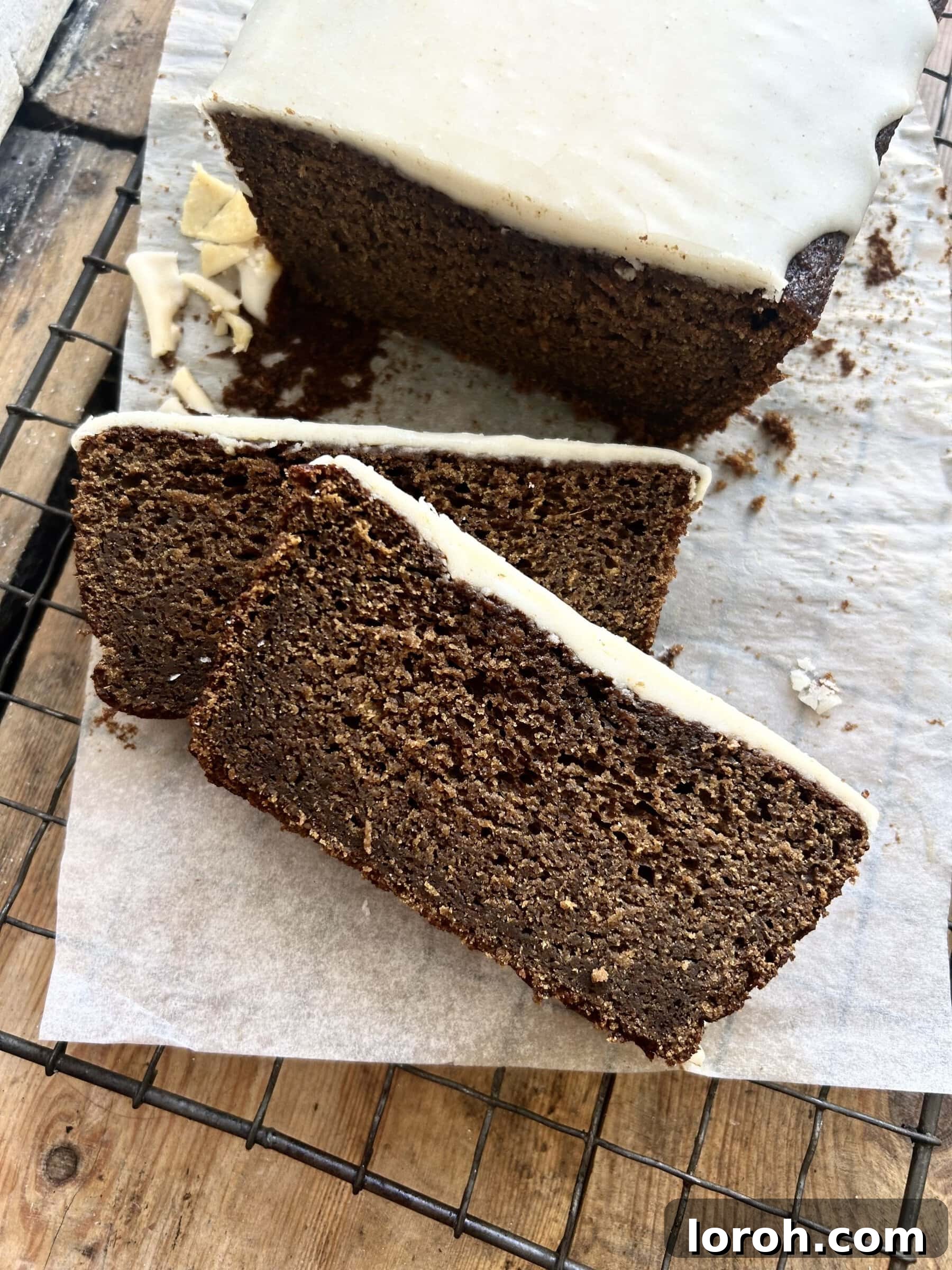 Island-Spiced Jamaican Ginger Cake 2 A deliciously moist and sticky Jamaican Ginger Cake on baking paper, beautifully golden brown.