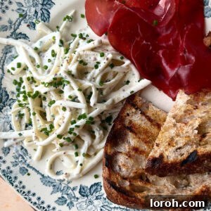 Zesty Celeriac Remoulade 11 celeri remoulade on plate with bread and cured meats.