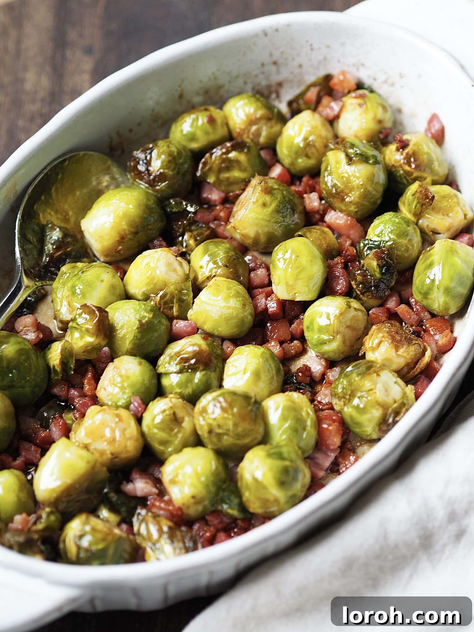 Roasted brussels sprouts with cooked bacon lardons tossed in honey and balsamic vinegar.