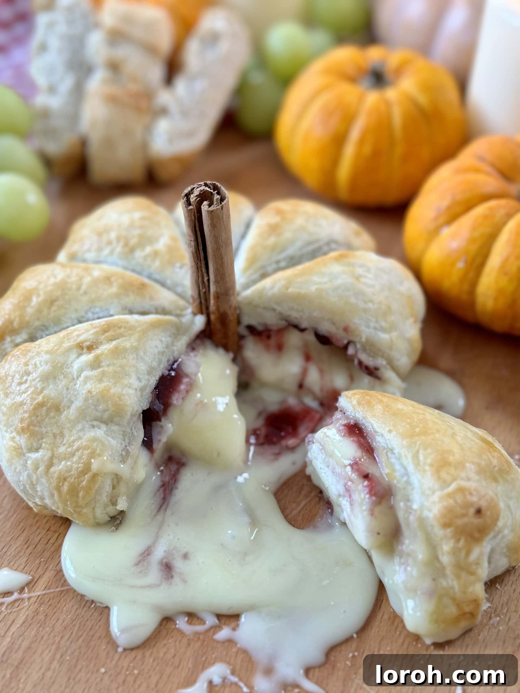 Garlic Cranberry Baked Brie in a Pumpkin Puff Pastry 3 Top-down view of a Baked Camembert and Cranberry Puff Pastry Pumpkin for Halloween, garnished and ready to serve.