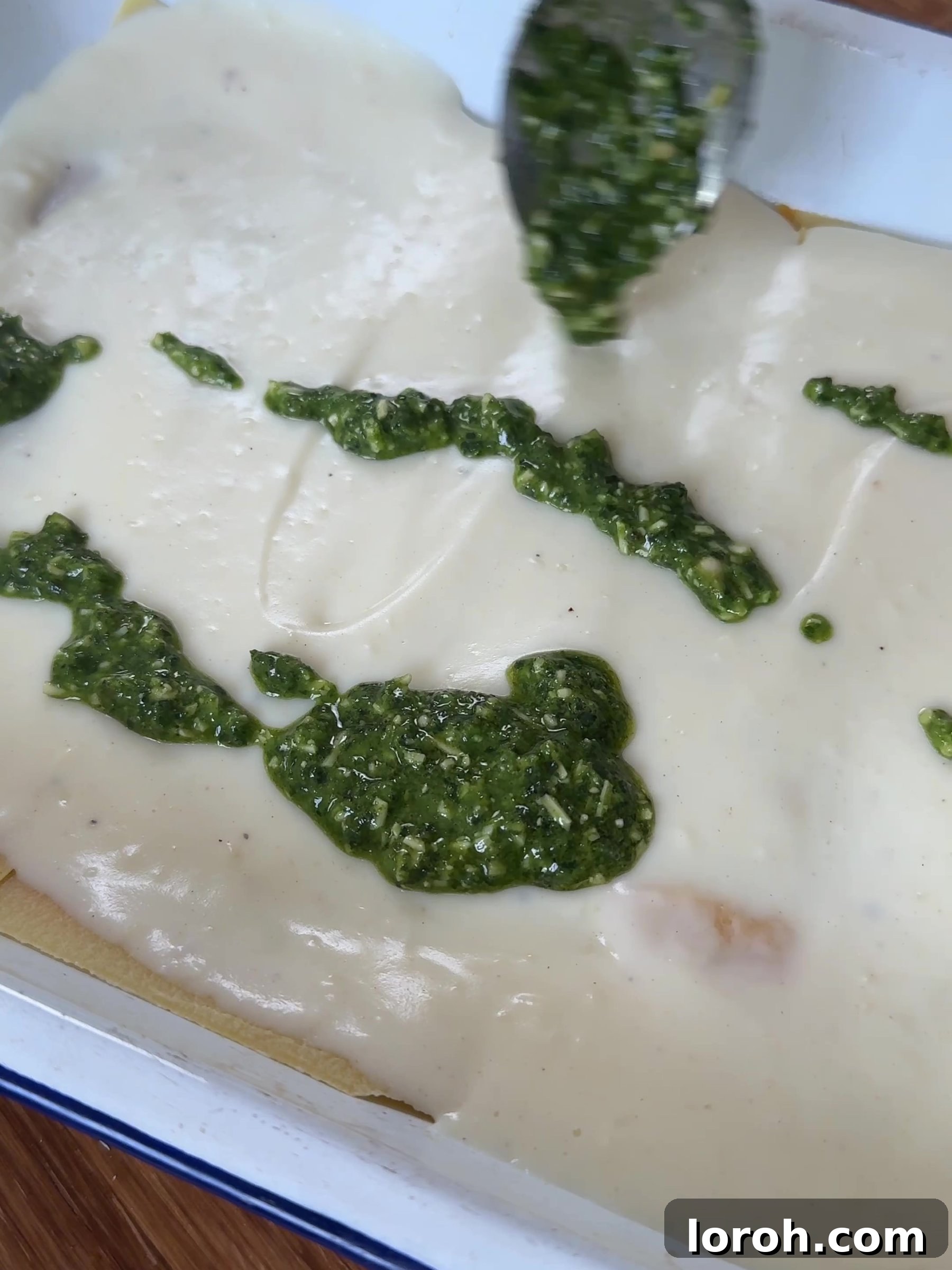 Basil Bliss Lasagna Bake 11 Dolloping fresh pesto over a layer of cheese sauce in the lasagne.