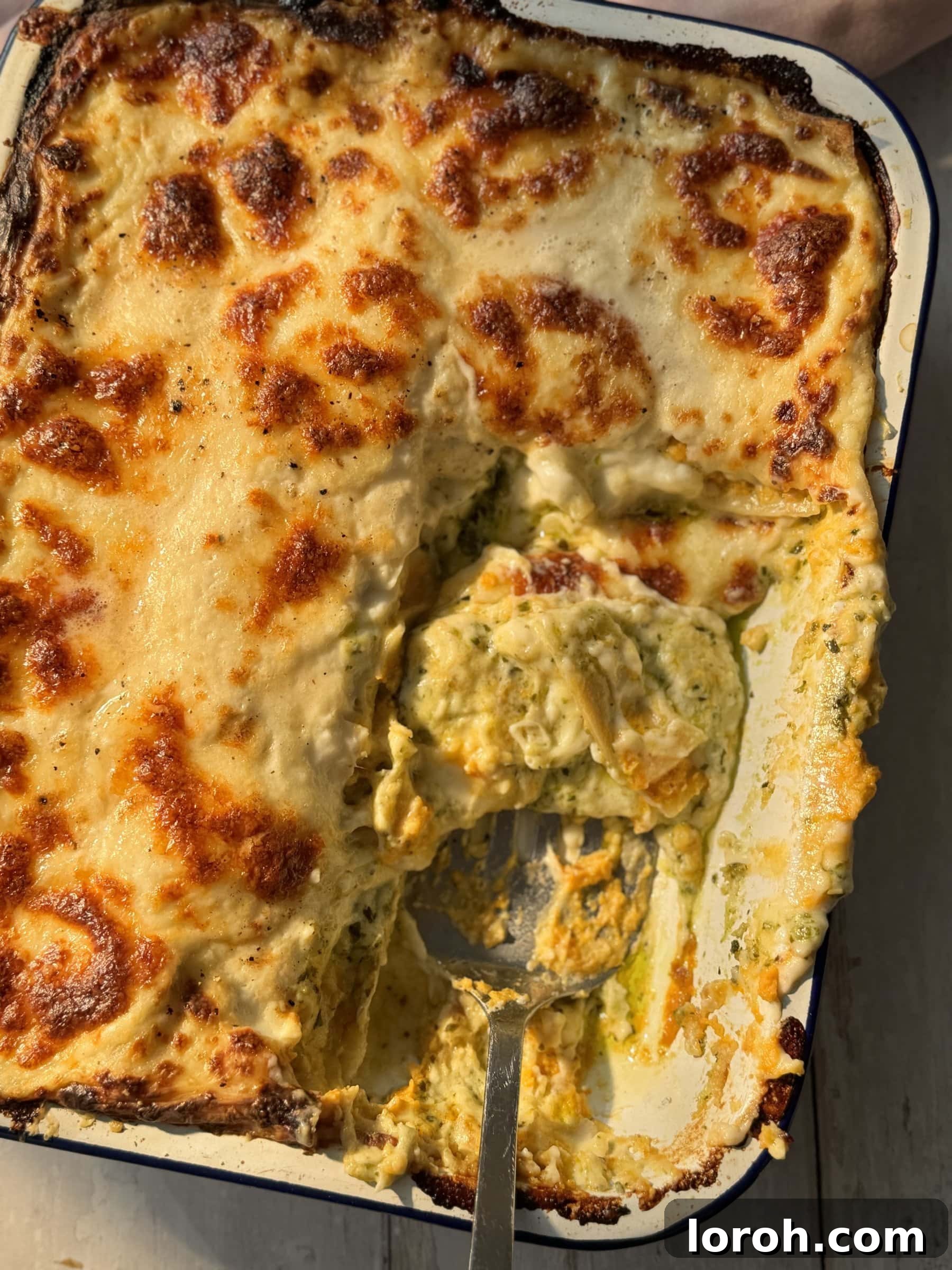 Basil Bliss Lasagna Bake 3 Close-up of baked Lasagne al Pesto with Butternut Squash, showing its golden-brown top and bubbling cheese.