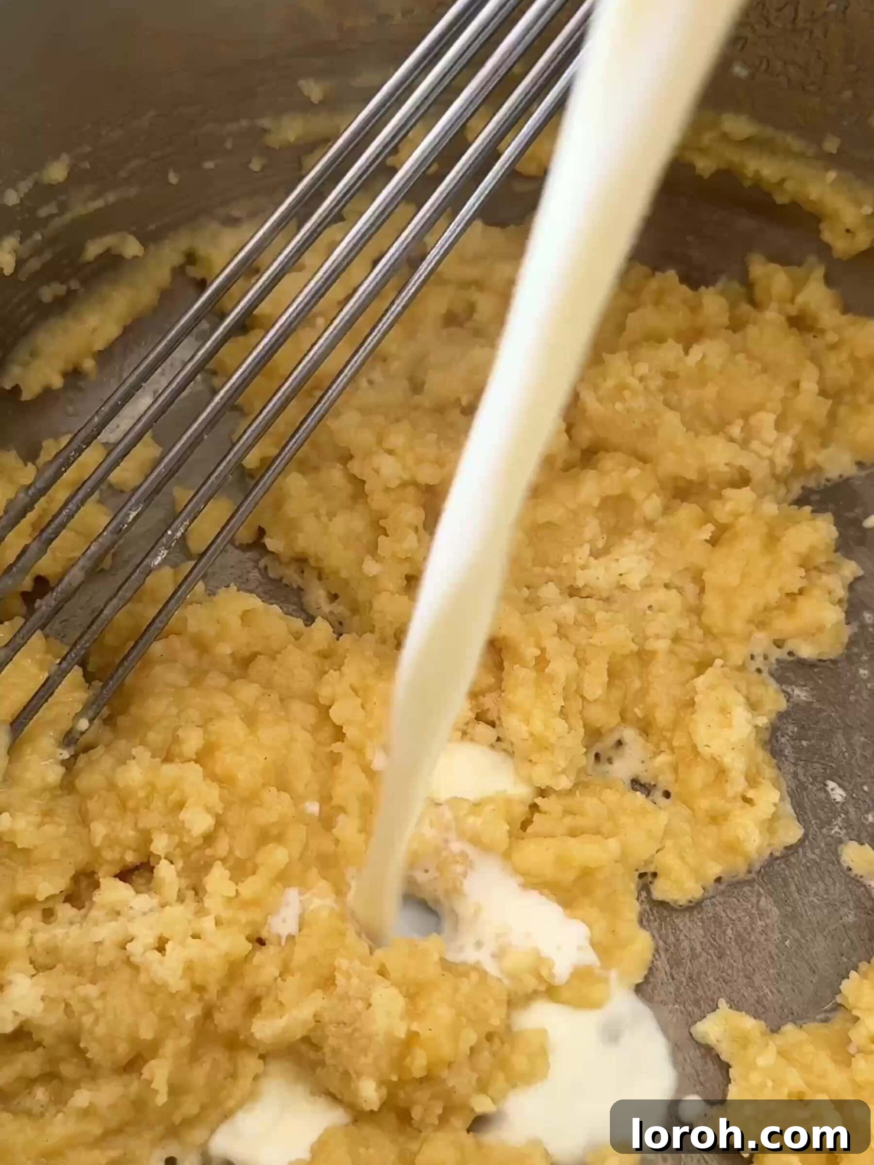 Basil Bliss Lasagna Bake 8 Gradually adding milk to the roux while whisking to create a smooth béchamel sauce.