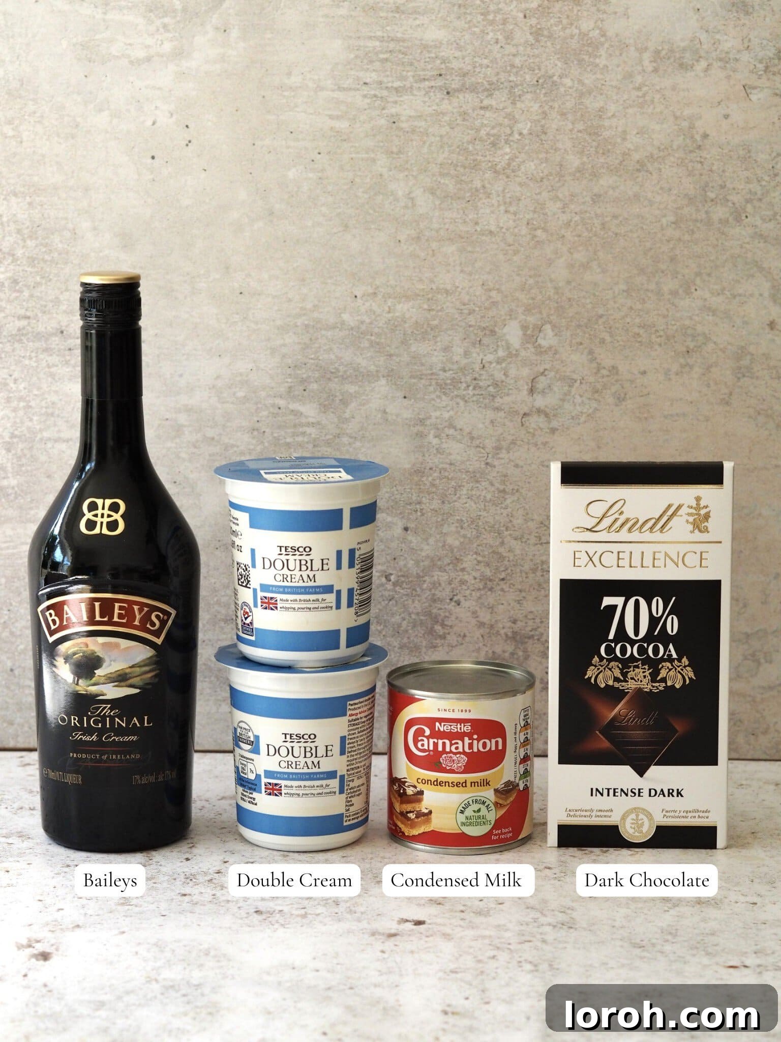 Baileys Velvet Ice Cream 3 Collection of ingredients required for making homemade Baileys Ice Cream, including cream, condensed milk, Baileys, and dark chocolate.