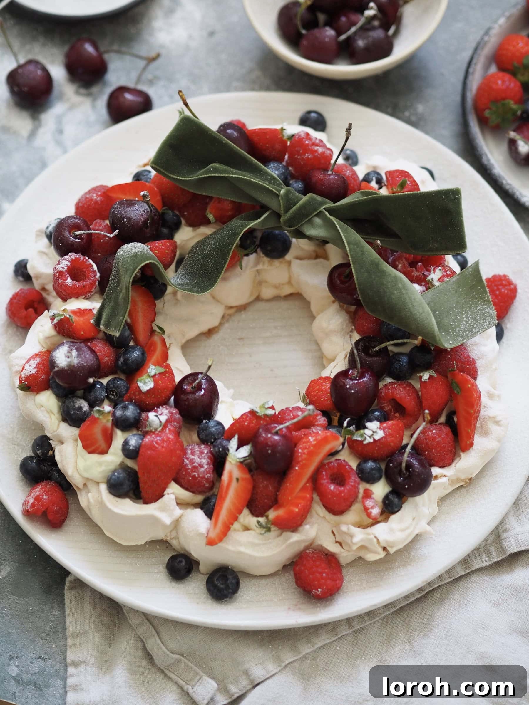 Festive Meringue Wreath 2 Christmas Pavlova on a plate with a ribbon