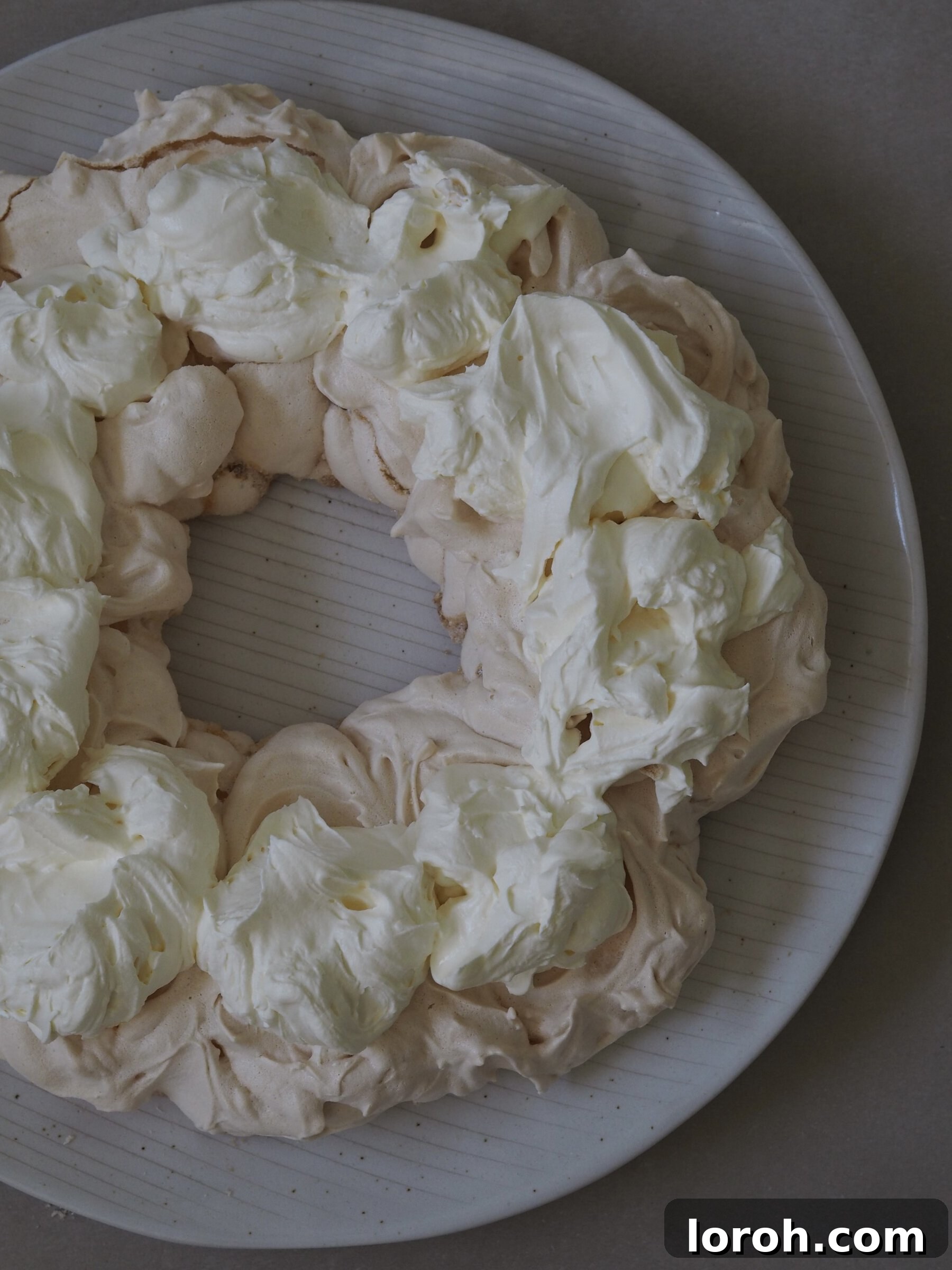 Festive Meringue Wreath 14 Adding whipped cream to the pavlova